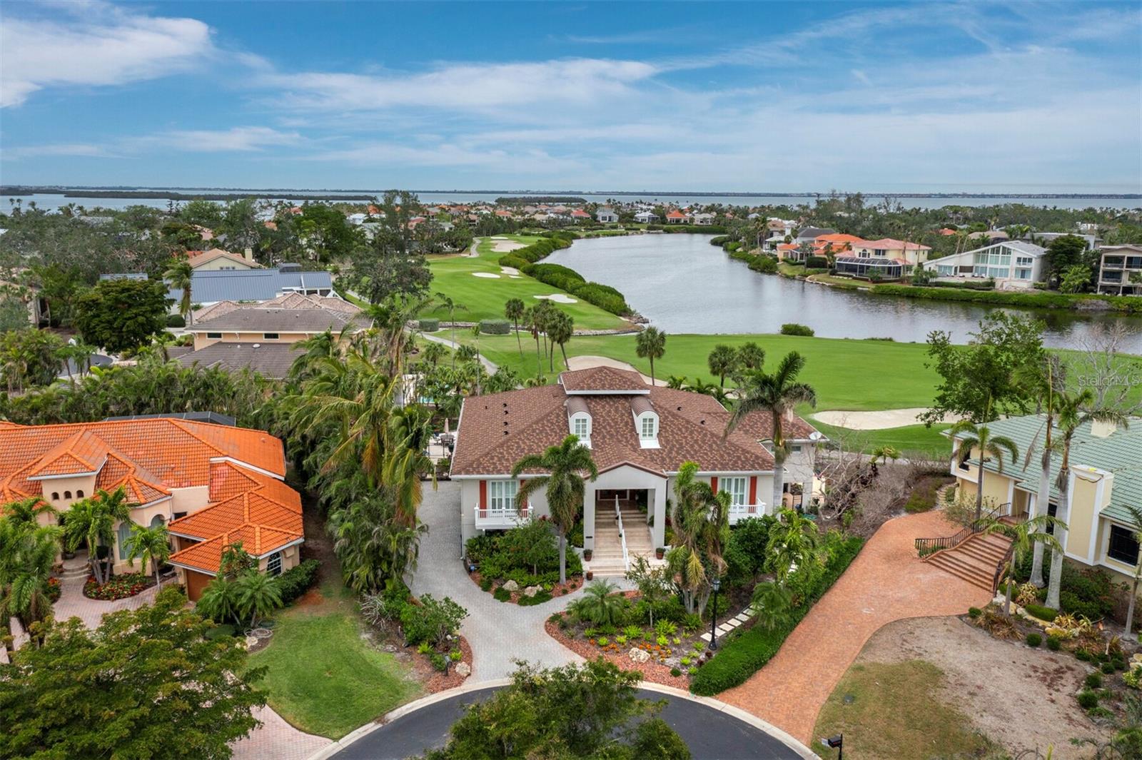 A stunning custom home where Coastal &Traditional merge into a true masterpiece. Lovingly remodeled and updated with high end finishes, spacious rooms, built-ins and high ceilings. All bathrooms are en-suite with additional powder bath. Custom kitchen with caesar stone counters and an abundance of cabinets, most with roll out shelves. Charming breakfast room. Natural gas cooktop burners, Jenn Aire appliances. 3 air conditioning systems (one brand new). Hurricane rated windows. 1 year old stone covered metal tile roof with transferable warranty. ($94,000 cost). All tv's & electronics stay. Furniture, accessories and some artwork available for purchase under separate bill of sale. Privately situated on prime cul-de-sac lot with serene lake & golf course views. Heated saltwater pool. covered patio, perfect for entertaining. Attached, oversized 6 car side entry garage. Access to private Bay Isles Beach Club included. with HOA membership. Located in prestigious Bayou neighborhood within Bay Isles. Just minutes to world class shopping and fine dining. A pleasure to show.
