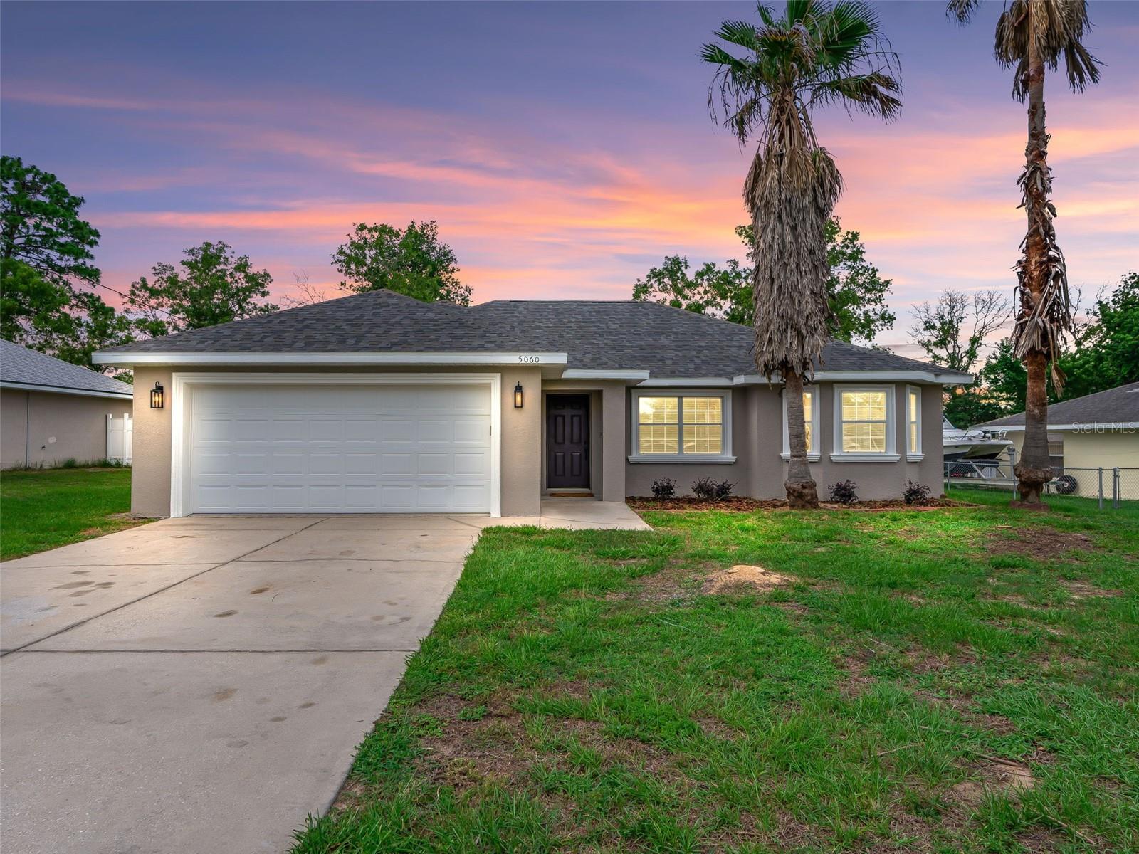 One or more photo(s) has been virtually staged. Fantastic opportunity in Silver Springs Shores - major updates all just completed! Situated on a spacious lot with mature palms that welcome you home. The covered front porch leads inside to the spacious, open floor plan featuring LVP flooring and vaulted ceilings. The open kitchen offers plenty of storage and counter space, a brand new suite of LG stainless steel WiFi enabled appliances including convection and air-fry capable range and French door fridge with door ice and water dispenser. The primary suite, located in the back of the home, offers a tray ceiling, spacious walk-in closet and ensuite bathroom with dual sink vanity, walk-in shower, linen closet and separate water closet. The opposite side of the home offers two bedrooms with brand new carpet, the front featuring a bay window while both share a bathroom with tiled shower/tub combo. The indoor laundry room boasts a utility sink and leads to the attached 2 car garage. All major updates just completed in 2026 - Roof, HVAC, Water Heater, Kitchen Appliances, interior and exterior paint, blinds and more. Please enjoy the attached 3D tour and interactive floor plan.