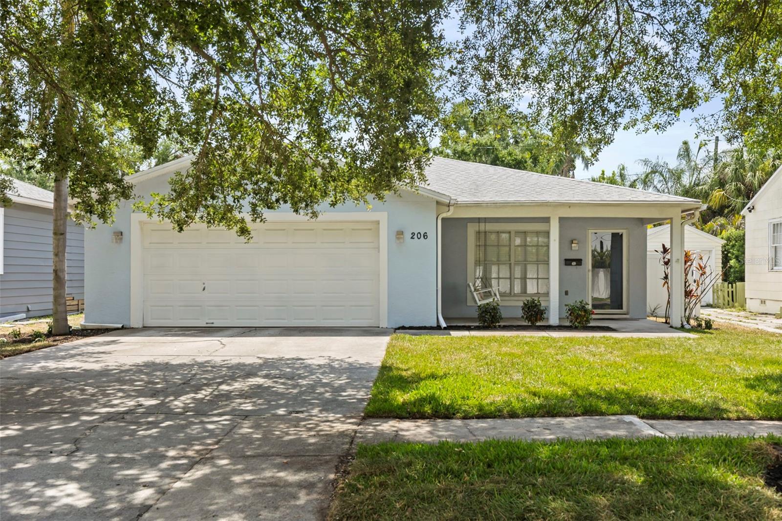 Welcome to 206 S. Himes Avenue, a beautifully updated home in the rarely available Gray Gables neighborhood of South Tampa. Perfectly positioned on a charming tree-lined area of Himes Ave, this move-in-ready 3-bedroom, 2-bath residence combines timeless character with modern updates and an unbeatable location.  Once inside you'll discover a bright, inviting floor plan featuring luxury vinyl flooring throughout, a beautifully remodeled kitchen with stainless steel appliances, and two stylishly updated bathrooms.  The spacious primary suite offers an en-suite bath and linen closet, while the flexible layout easily accommodates family, guests, or a private home office.  A large interior laundry room and oversized two-car garage with built-in storage cabinets add everyday convenience. Outside, the paved patio overlooks a fully fenced backyard with ample space to create your ideal outdoor oasis. The backyard space has been intentionally left as a blank canvas for the new owners. Imagine fresh landscaping, a private pool, or the custom outdoor design of your dreams.  The most recent updates include a brand-new A/C system (2026) and new front-yard sod and landscaping (2026), and new two car garage door motor, providing added value and peace of mind.  Located within the highly desirable Mitchell Elementary, Wilson Middle, and Plant High School attendance area (buyer to verify school assignments) and just minutes from Hyde Park Village, Midtown Tampa, Downtown Tampa, Tampa International Airport, Raymond James Stadium, and some of the city's best dining, shopping, and entertainment.  This home offers the absolute best, where luxury, privacy, and location come together in one exceptional South Tampa residence. Schedule your private showing today and experience firsthand what makes this home so special.