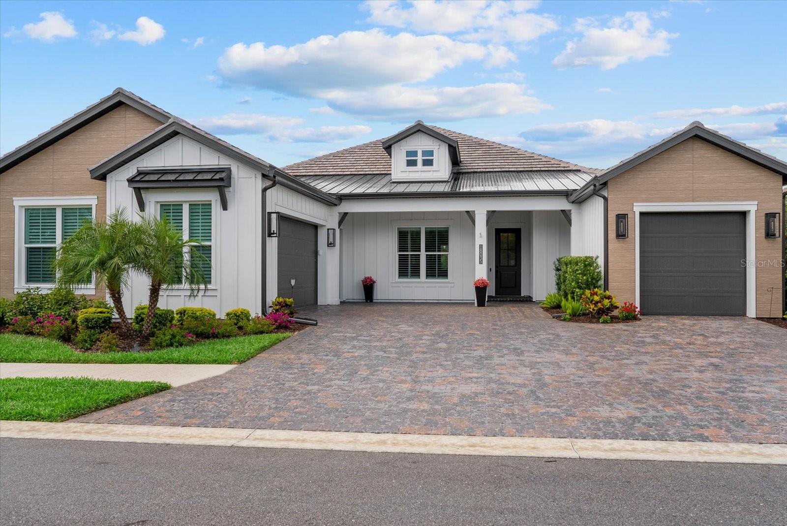 Experience elevated Florida living in this exceptional SAM RODGERS CUSTOM POOL HOME with 4-bedrooms, 3 full bathrooms, 3 1/2 Car Garage residence offering over 2,900 square feet, perfectly positioned on a tranquil pond with protected green space behind and in front of the home with over 40 acres of natural preserves —ensuring privacy and serene views that will never be built on. With only 42 homes in this private gated community, this property showcases superior craftsmanship and thoughtful design throughout—and is walkable to the highly sought-after Wellen Park, offering convenient access to dining, shopping, and vibrant community events.

With over $395,000 in builder upgrades, this home seamlessly blends luxury, style, and functionality. The striking curb appeal is enhanced by modern Nichiha architectural siding on the front elevation, setting the tone for the high-end finishes found throughout. Inside, you’ll find wood beams, luxury vinyl flooring, and plantation shutters throughout, creating a warm yet sophisticated ambiance.

Designed for effortless entertaining, the home features a dramatic 90-degree sliding glass door that opens to a large covered lanai, extending your living space outdoors. The chef’s kitchen is elevated with custom pantry storage and under and above cabinet lighting, combining elegance with everyday practicality.

The primary suite is a true retreat, complete with a custom vanity and a spa-inspired bath featuring a Kohler soaking tub. Every closet has been thoughtfully designed with custom built-ins, offering exceptional organization throughout.

Step outside to your private oasis, where a panoramic screen enclosure frames breathtaking water and preserve views. The fully equipped outdoor kitchen with gas grill, refrigerator and sink makes year-round entertaining a breeze.

Additional premium features include hurricane-impact windows and sliders, a mini-split A/C unit in the garage, polyaspartic garage floors (more durable than epoxy), gutters, a tankless gas water heater, and a dedicated electric vehicle charging outlet.

This meticulously upgraded home offers a rare combination of luxury finishes, modern convenience, and an unbeatable location—delivering the ultimate Florida lifestyle.