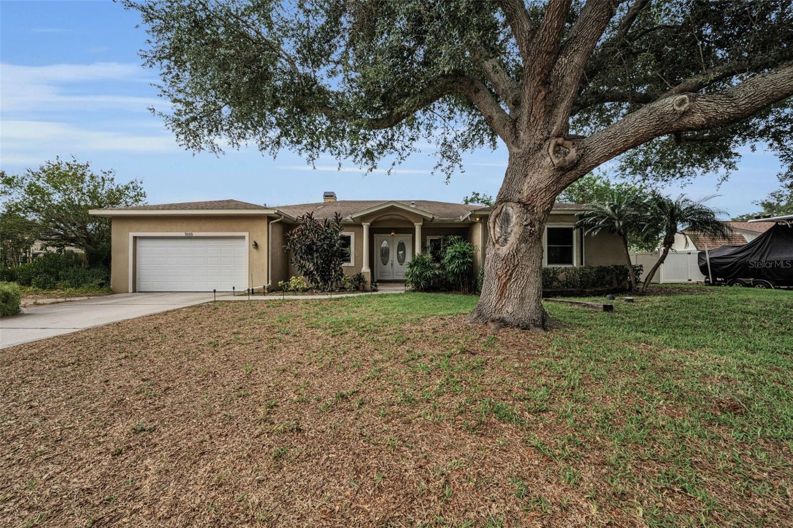One or more photo(s) has been virtually staged. A Rare Multigenerational or Multi-Family Opportunity in the Heart of Clearwater!
Stunning 4-bedroom, 3-bath, 2-half bath, single-story home built in 2007 with newer building code, offering 3,042 square feet of luxurious living with mature landscaping and NO HOA. From the moment you arrive, lush tropical landscaping, swaying palms, and a charming front garden pond set the tone for everything this exceptional home has to offer.
Step inside through the grand 9x9 foyer and you are immediately greeted by 10-foot ceilings, rich crown molding throughout, 5.5-inch baseboards, knock-down ceilings, and an abundance of natural light through impact windows. Every detail has been thoughtfully curated — from the upgraded two-panel doors with nickel finish knobs and accents to the fresh interior and exterior paint on all doors, trim, and casings. Fully wheelchair accessible.
The heart of this home is the spacious 11x20 kitchen, featuring solid wood cabinetry with crown and base trim, elegant Corian countertops, nickel faucets, and natural gas cooking.  The City of Clearwater provides natural gas service for the stove, fireplace, dryer and heat source.  The adjacent 10x13 dining room flows seamlessly into the 15x13 living room, where a natural gas fireplace creates the perfect gathering space. 
The grand primary suite measures an impressive 15x20 and features double-door access directly onto the covered, expansive pavered back patio. The spa-inspired primary bath includes Corian countertops, an upgraded 7x9 walk-in shower with brand new glass door and panel, an inside linen closet, a private toilet room, and a luxurious Oceania AeroMassage tub. The 10x11 primary walk-in closet is a room of its own!
Two generously sized Jack and Jill bedrooms — 13x17 and 13x14 — share a beautifully appointed 8x11 bathroom with a new shower door. Bedroom 2 boasts both a built-in and a walk-in closet, while Bedroom 3 features a 4x6 walk-in closet and its own 6x8 office area — ideal for a student, guest, or second work-from-home space. Bedroom 4 serves as a second grand primary suite, complete with a walk-in closet and walk-in shower.
Work from home in style with a generous 9x9 dedicated office featuring a separate alcove perfectly sized for a V-shaped executive desk. The home also features a convenient 6x6 powder room and a 4x7 pool half bath and outdoor shower — already in place for a future pool addition. Adjacent to the office, on the other side of the foyer, is an incredible bonus room previously used as a music room, featuring sound-insulated walls and a dramatic double-door entrance — the perfect creative space, media room, or private retreat.
The 9x7 laundry room is fully loaded with a Whirlpool front-load washer and dryer, a utility mud sink, cabinetry, and hanging space. The oversized 22x27 deep garage features a newer garage door (2024) with ample room for two vehicles plus attic storage.   The HVAC system was replaced in 2022 and a Tankless HWH was installed 2026.
Outdoors, relax and entertain on the expansive 13x40 covered pavered back patio, perfect for hosting family and friends year round. Beyond the patio, escape to your own private tropical oasis — a 16x23 outdoor entertainment area complete with a fire pit, tiki torches, and a sandy, beach-inspired atmosphere that captures the true spirit of Florida living. 
Conveniently located in the heart Clearwater, minutes from world-class beaches, dining, shopping, and top-rated schools. A Must See!