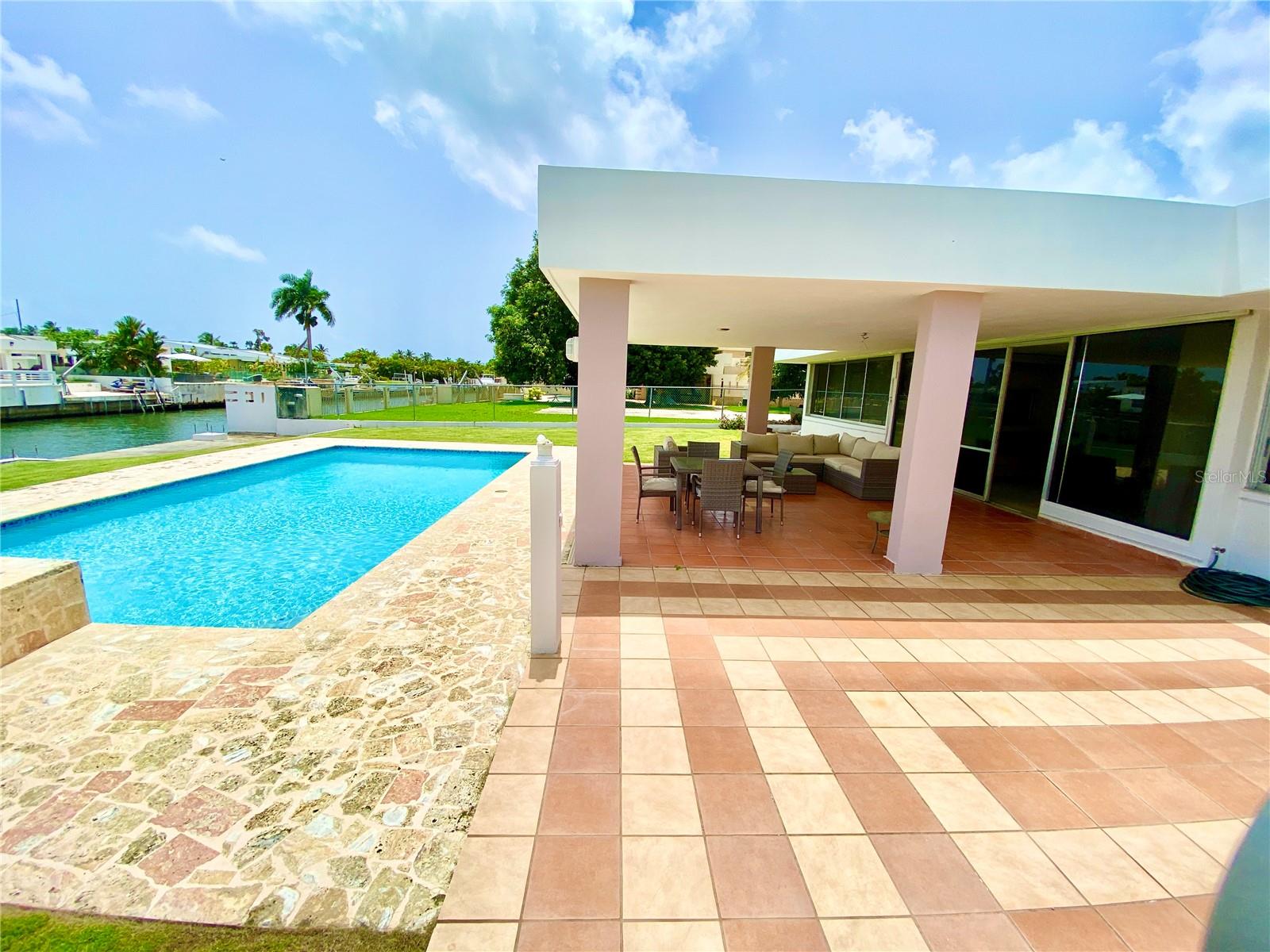 Located in one of the most exclusive communities in the metro area Vistamar Marina Este, this stunning waterfront home offers a private dock with direct access to a saltwater canal right in your backyard, perfect for boating, fishing, or enjoying serene views. Designed for luxury and comfort, the property features an expansive concrete terrace ideal for outdoor entertaining, a swimming pool with a view, a spacious open-concept layout seamlessly connecting the living, dining, and kitchen areas, and 4 bedrooms with 3 full bathrooms, including a master suite. With modern finishes and access to exclusive community amenities, this home perfectly blends elegance, convenience, and a vibrant coastal lifestyle. Open to offers!