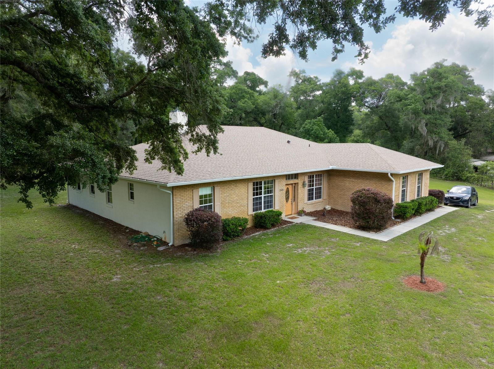 Welcome to your peaceful slice of country heaven! Original owner and well-maintained! This tucked away on 2.5 acres on a quiet dead-end road, this spacious 2007 block-and-brick home offers the perfect blend of privacy, comfort, and room to breathe. With A-3 zoning, no flood zone, a 2023 roof and gutters, and a new drainfield installed in 2019, this property is ready for its next owner to enjoy.

Step inside through the large, inviting foyer, where you are greeted by a bright, open-concept floor plan with 10-foot ceilings throughout, double-pane windows, and no carpet. Offering 2,318 square feet, this home features 3 bedrooms, a large office/den, an inviting game room, a spacious formal dining room, and a large walk-in storage room. The spacious family room is warm and welcoming with a fireplace and heat blower, creating the perfect place to gather on cooler evenings.

The kitchen is open and functional with granite countertops, with a breakfast bar, a pantry, and plenty of space for entertaining. The game room adds extra flexibility, and the pool table conveys, making it ready for fun from day one. A convenient half bath leads out to the oversized covered back patio, where you can relax, unwind, and enjoy the peaceful backyard views.

The large and bright primary suite offers private backyard access and a beautiful ensuite bath with a tiled walk-in shower, dual vanities, a makeup vanity, and plenty of shelving for towels and linens. Guest bedroom one is spacious and full of natural light, complete with both a double closet and a single closet. Guest bedroom two is also bright and comfortable with a double closet.

Additional features include an interior laundry room, a 2-car garage, formal dining space, and plenty of storage throughout. Outside, the 2.5-acre setting gives kids and grandkids room to run free, play, explore, and enjoy the simple beauty of country living.

Peaceful, private, and full of charm, this property is the perfect place to slow down, spread out, and truly feel at home.
 Please note that all information and measurements are provided for accuracy, but are not guaranteed to be accurate. Buyers and their agents should verify all property details, including zoning, schools, HOA rules, pet policies, and other potential uses.