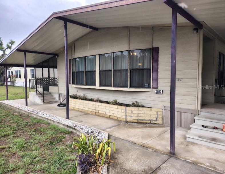 What a Find!! Nice double-wide manufactured home on a nice big corner lot with no HOA or lot fees. This large 2 bedroom 2 bath home features an open floor plan with a nice big master bedroom with it's own master bath and walk in closet all  tucked away in the back of the home. There is also an nice big air conditioned Florida room with lots of windows. Outside you will find a 2 car carport with electric car chargers included! 2 Workshops - one behind the carport and the other in the back yard. There will be furniture left by out of state owner that you can keep or donate as well. 

Don't let this one slip away!