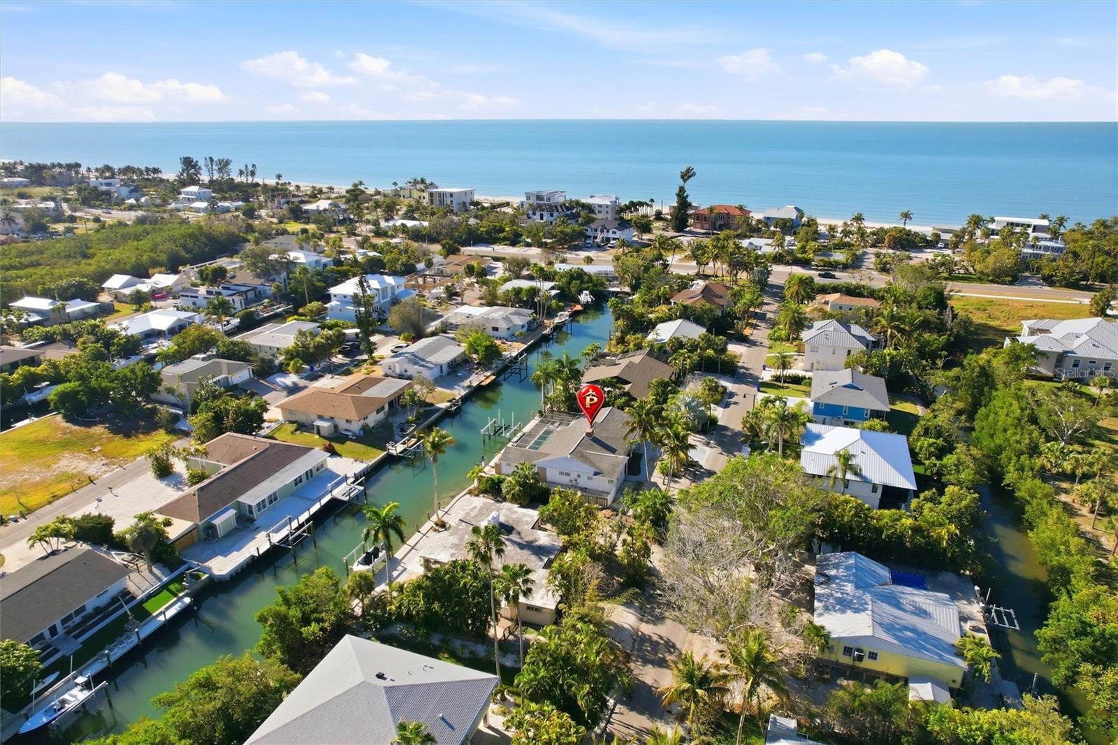 Imagine living the coastal lifestyle only dreams are made of! Wake each morning to the sunrise over your local beach—just a short stroll down the street—where you can sink your toes into sugary white sand, take an early walk, or collect seashells along the shore. Return home to enjoy coffee outdoors by your heated pool, relaxing on the deck as tranquil water views set the tone for the day. Take a refreshing dip, then unwind as nature’s canvas unfolds before you, with shifting light and brilliant shades of blue and azure.

In the evening, hop on your boat from your backyard and cruise effortlessly to waterfront restaurants and sunset destinations. With a 20,000-lb boat lift, personal watercraft lift, and a 40-foot dock on a deep-water canal, you’ll enjoy immediate access to Sarasota Bay, the Intracoastal Waterway, and the Gulf—with no fixed bridges along the way. End your days with breathtaking sunsets as the sky ignites in color, dolphins play, and manatees glide by.

Inside, the home offers an optimal floor plan ready for your personal touches. The spacious eat-in kitchen features an expansive island perfect for casual entertaining, complemented by new stainless-steel appliances. A wall of sliding glass doors seamlessly blends indoor and outdoor living, filling the home with natural light and water views. All main living areas open to the pool and outdoor spaces. Recent updates include a new AC system and a recently refinished pool. The home offers three bedrooms and four baths, with the flexibility to modify the layout or easily add a fourth bedroom. A wood-burning fireplace adds warmth and charm to the living room.

Located on the barrier island of Longboat Key, this exceptional property is perfectly suited for the most discerning buyers. Enjoy nearby golf, pickleball, boutique shopping, and dining, with St. Armands Circle and downtown Sarasota just minutes away. Convenient access to SRQ Airport makes this an ideal full-time residence or luxury vacation retreat.

Call today to schedule your private showing and experience coastal living at its finest.