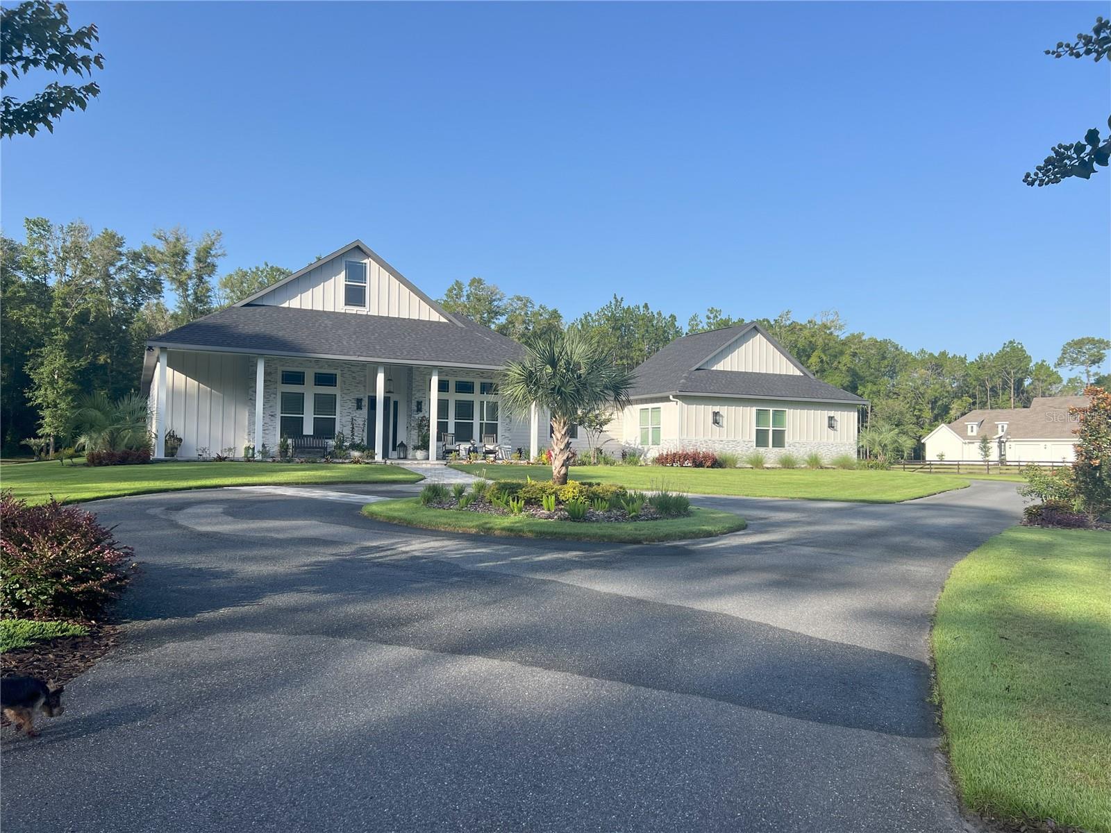 Welcome to this exceptional custom-built estate in the gated community of Foxridge, offering a rare combination of luxury, privacy, and functionality on over 7 beautifully landscaped acres.

Built in 2022, this thoughtfully designed 4-bedroom, 4-bath residence with a dedicated study showcases high-end craftsmanship and an open, inviting layout. Soaring 12’ and 16’ ceilings, including a stunning vaulted ceiling with exposed beams, create a spacious and light-filled main living area ideal for both everyday living and entertaining.

The gourmet kitchen is a true centerpiece, featuring stacked all-wood cabinetry, waterfall quartz countertops, premium Z-Line appliances, and a custom Coppersmith hood extending to the ceiling. A wet bar with an additional fireplace and seamless flow to the outdoor living space enhances the home’s entertainment appeal.

Step outside to your private retreat, where an inground saltwater pool is surrounded by extensive hardscape and mature landscaping. Multiple outdoor living areas include a covered lanai with 12-foot pocket sliders, a linear gas fireplace, and a separate patio with a wood-burning firepit—perfect for enjoying Florida’s year-round outdoor lifestyle.

The property also features a detached, pull-through RV and boat garage with a heated and cooled flex space that offers incredible versatility and can easily function as an in-law suite, guest house, tack room, workout space, or additional living area—providing endless possibilities to suit a variety of needs.

Additional highlights include a split-bedroom floorplan for added privacy, an interior in-law suite with a private entrance, luxury vinyl plank and tile flooring throughout, electric fireplaces in both the main living area and wet bar, a whole house generator, a private well and septic system, and a 3-car attached garage with additional parking options.

Conveniently located just minutes from Gainesville and Alachua with easy access to Interstate 75, this property offers both seclusion and accessibility.

This is a unique opportunity to own a meticulously crafted estate that blends modern luxury with expansive outdoor living. Schedule your private showing today to experience all this property has to offer.
