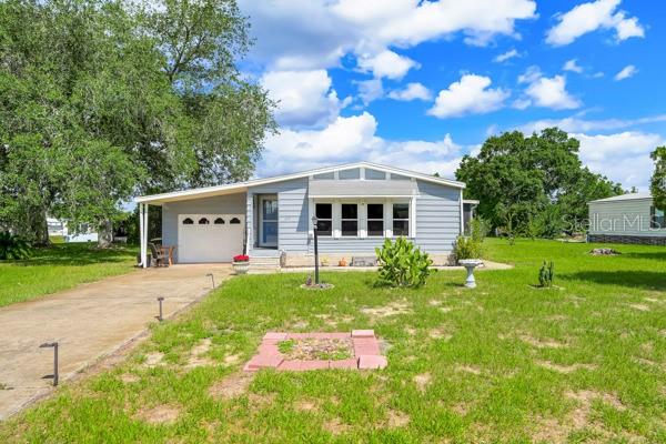 Welcome home to your Florida Retirement Lifestyle!  This charming 2-bedroom, 2-bath manufactured home is located in a desirable 55+ golf cart-friendly community! Nestled on a peaceful cul-de-sac.  This spacious home offers a comfortable and functional floor plan designed for both relaxation and entertaining.
Inside, you'll find a spacious living room, a well-appointed kitchen featuring a center island, a separate dining room, and a convenient wet bar area perfect for hosting family and friends. The den/study provides flexible space for a home office, hobby room, or reading retreat. The primary suite offers comfort and privacy, while the second bedroom and bath are ideal for guests.  The lanai offers extra space for entertainment.  
Additional features include a one-car garage, plus an outdoor shed with workshop space for storage, projects, and hobbies.
Enjoy an active lifestyle with access to the community's swimming pool, golf course, and numerous amenities and activities. Whether you're looking for a year-round residence or a seasonal getaway, this home offers the perfect blend of comfort, convenience, and community living. Schedule your private showing today and discover all that this wonderful home and community have to offer!