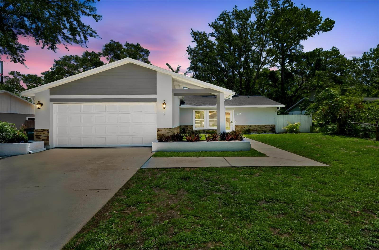 Located in an established Safety Harbor neighborhood with no mandatory HOA fees, this 3-bedroom, 2-bath home offers 1,393 square feet of comfortable living space, a functional layout, and thoughtful improvements throughout. Fresh exterior paint and a new front door with decorative glass detailing, both completed in 2026, contribute to the home's updated appearance and welcoming curb appeal while allowing additional natural light into the entryway. Inside, vaulted ceilings, crown molding, bamboo flooring, and a wood-burning fireplace with a quartz facade create a warm and inviting atmosphere. The open-concept layout, combined with large windows and sliding glass doors, allows for good natural light throughout the home's main living spaces, creating a bright and comfortable environment. The kitchen features granite countertops, 42-inch white cabinetry, stainless steel appliances, pendant lighting, and a breakfast bar that serves as a natural gathering space. The split-bedroom floor plan provides privacy for the primary suite, which includes a walk-in closet and a fully renovated bathroom completed in 2024. The updated space features a spacious walk-in shower with a frameless glass enclosure, modern tilework, a floating vanity, and contemporary finishes that create a clean and inviting feel. Additional improvements over the past several years include Trane HVAC system installed in 2021, whole-house water filtration, reverse osmosis and water softener systems, updated appliances, and a new washer and dryer, contributing to the home's move-in-ready appeal. An indoor laundry room and attached two-car garage add everyday convenience. Outside, an expansive paver patio creates a welcoming outdoor living space and extends along the side of the home, providing additional functionality and easy access around the property. The fenced backyard offers space for outdoor dining, gardening, pets, and relaxation, while the property's location outside of a flood zone provides added peace of mind. Situated within highly rated Pinellas County school zones and just minutes from downtown Safety Harbor, residents enjoy convenient access to locally owned restaurants, shops, waterfront parks, community events, the Safety Harbor Resort & Spa, Philippe Park, the Pinellas Trail, and nearby boating, fishing, and kayaking opportunities. Clearwater Beach (20 minutes), Honeymoon Island (25 minutes), Tampa International Airport (20 minutes), and St. Pete-Clearwater International Airport (15 minutes) are all within easy reach. With major shopping destinations, medical facilities, and employment centers nearby, this location offers convenient access to everything the Tampa Bay area has to offer.
