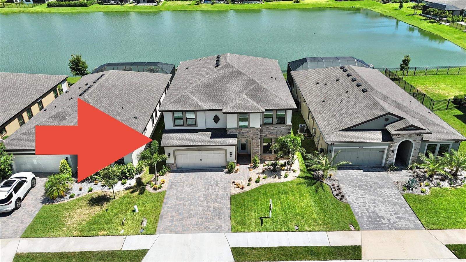 Welcome to one of the most extensively upgraded homes in Crosswind Point, where luxury, functionality, and resort-style outdoor living come together on a premium waterfront homesite.

Built in 2023, this impressive Homes by WestBay Avocet II offers approximately 3,352 square feet of thoughtfully designed living space with 5 bedrooms, 3 full bathrooms, a private den, expansive bonus room, and a 3-car tandem garage. Even better, the home still benefits from the remainder of the builder’s transferable warranty, providing added peace of mind for the next owner.

The highly sought-after floor plan features an open-concept design ideal for entertaining while providing flexibility for multi-generational living, remote work, hobbies, or growing families. The first floor includes a private guest bedroom and full bath, spacious den, oversized grand room, chef-inspired kitchen with a large center island, walk-in pantry, and seamless connection to the dining area and covered lanai. Upstairs you’ll find a massive bonus room, luxurious owner’s retreat, oversized walk-in closet, and three additional bedrooms.

What truly separates this home from the competition is the extraordinary investment in upgrades and outdoor living. Step outside to your private resort-style backyard featuring a stunning 13’ x 26’ saltwater pool with an elevated 8’ x 8’ spillover spa, oversized sun shelf with in-water loungers, LED lighting, fountains, water features, and breathtaking pond views. The desirable southern rear exposure provides abundant natural light throughout the day while creating the perfect backdrop for enjoying Florida’s spectacular sunsets.

Additional upgrades include professionally designed landscaping with decorative concrete curbing and rock landscape beds, high-efficiency underground irrigation, rear second-story gutters, privacy wall on the lanai, garage epoxy flooring, ceiling-mounted storage racks, custom trim work in the flex room, upgraded tile extending to the ceilings in all showers and behind the kitchen range, custom owner’s suite closet system, UV purification systems and surge protection on both HVAC units, Ring security cameras, and a custom under-stair doghouse/playhouse. Entertainment enthusiasts will appreciate the impressive 120-inch laser projection system.

The attractive Craftsman-style exterior showcases stone accents, architectural shingles, paver driveway, lush tropical landscaping, and outstanding curb appeal. Situated on a premium pond lot within desirable Crosswind Point, residents enjoy access to community amenities, walking paths, playgrounds, and convenient proximity to I-75, Lakewood Ranch, Tampa, St. Petersburg, Sarasota, shopping, dining, and Gulf Coast beaches.

This is a rare opportunity to own a move-in-ready waterfront home loaded with premium upgrades that would be difficult and costly to replicate today. Combining luxury indoor living, exceptional outdoor entertaining space, a premium homesite, and remaining builder warranty coverage, this property truly offers the complete Florida lifestyle.