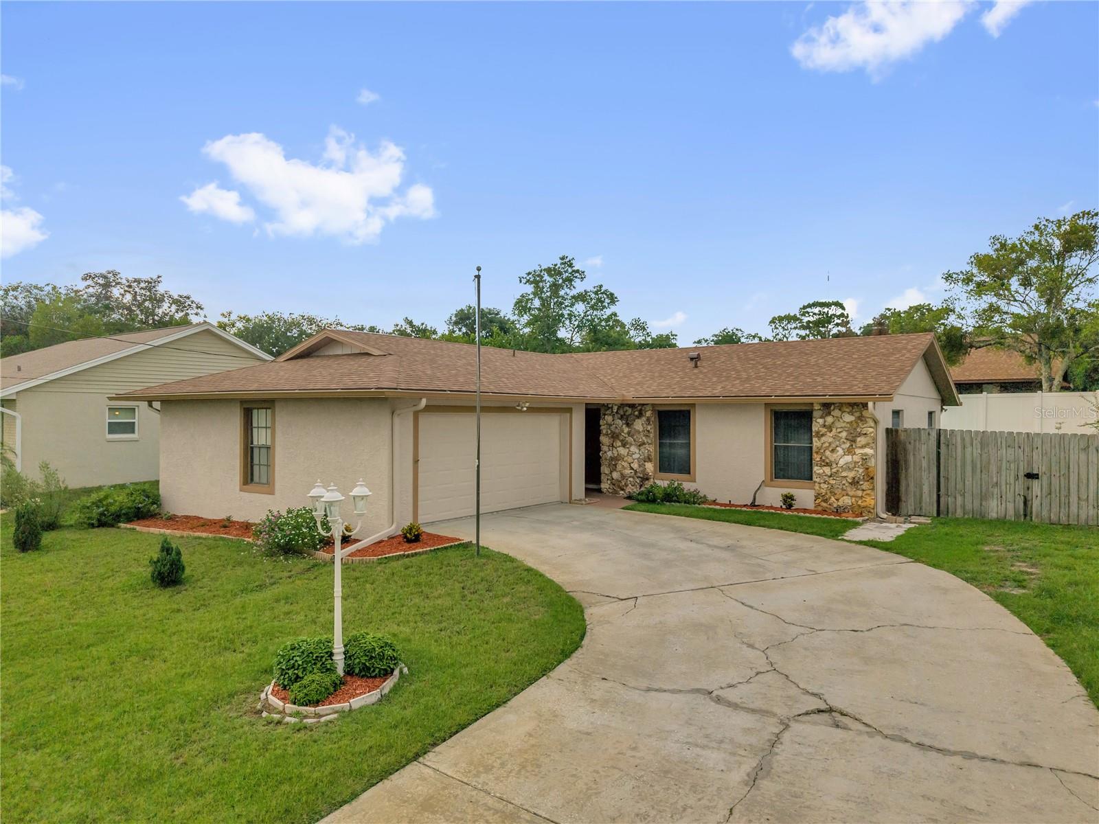 Nestled in the peaceful, lakefront community of Lake Marie Estates in DeBary sits this charming 3-bedroom, 2-bathroom gem. Pride of ownership shines throughout this meticulously maintained home, which offers fresh exterior paint, an oversized lot, a long private driveway, side-entry garage, and a 2024 roof. Inside you’ll love the all-tile flooring, neutral color palette, and open great room floor plan. A bright, fully enclosed Florida room provides wonderful additional living space. The primary suite features a private en-suite bath with walk-in shower, while the two guest bedrooms share a well-appointed bath with tub/shower combo and enjoy plenty of closet space. The kitchen offers generous counter and cabinet space with a sunny window, and it flows easily into the formal dining area. Outside, the large fully fenced backyard includes a double gate perfect for storing toys, creating a garden, or adding a play area. With no HOA, the possibilities are endless. The home sits slightly elevated and enjoys beautiful water views of Lake Anna Maria just across the street. This turn-key property makes an excellent primary residence or a strong income-producing investment. Don’t miss this exceptional value in a wonderful lakeside setting!
