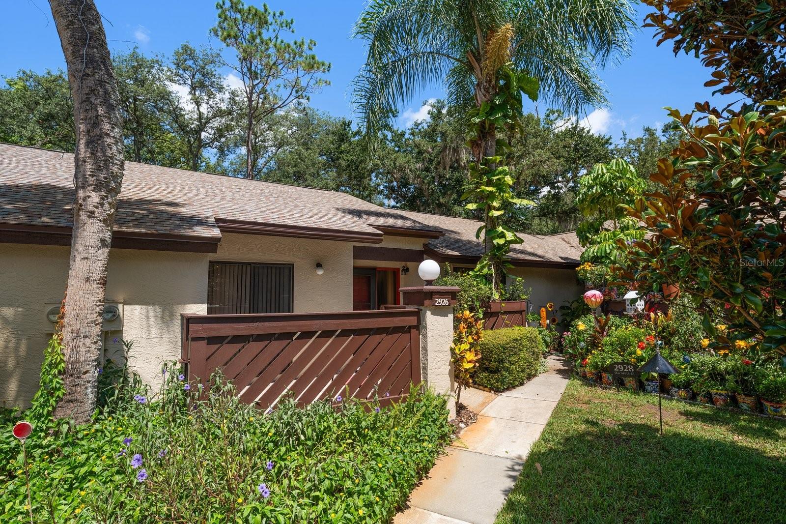 MAINTENANCE-FREE LIVING IN PALM HARBOR! Welcome to this desirable one-story villa located in the sought-after Strathmore Gate-East community, a pet-friendly neighborhood where all ages are welcome. Situated in a non-flood zone, this spacious residence offers 3 bedrooms, 2 full bathrooms, and nearly 1,300 square feet of comfortable living space. Designed with an open-concept layout, the home features a generous living and dining area that flows seamlessly into the kitchen, creating an ideal setting for everyday living and entertaining. The kitchen features oak cabinetry, tile countertops, tile backsplash and sliding glass doors that lead to a private patio, providing the perfect place to enjoy Florida’s year-round sunshine. The spacious primary bedroom features an en-suite bath with a tub/shower combination, separate vanity area, dual closets and private access to the covered/screened patio. A secondary bedroom also offers direct patio access, creating a bright and inviting retreat for guests or family members. Additional highlights include an inside laundry area large enough to accommodate a full-size washer and dryer, a private storage closet, colorful mature landscaping, and a roof that is approximately three years old. Residents enjoy easy access to the community pool and tennis courts, both within walking distance from the property. Conveniently located in the heart of Palm Harbor near shopping, restaurants, grocery stores, Gulf beaches, Tampa International Airport and everything the Palm Harbor area has to offer, this villa presents an exceptional opportunity to enjoy the Florida lifestyle. Zoned for the Top-Rated schools.