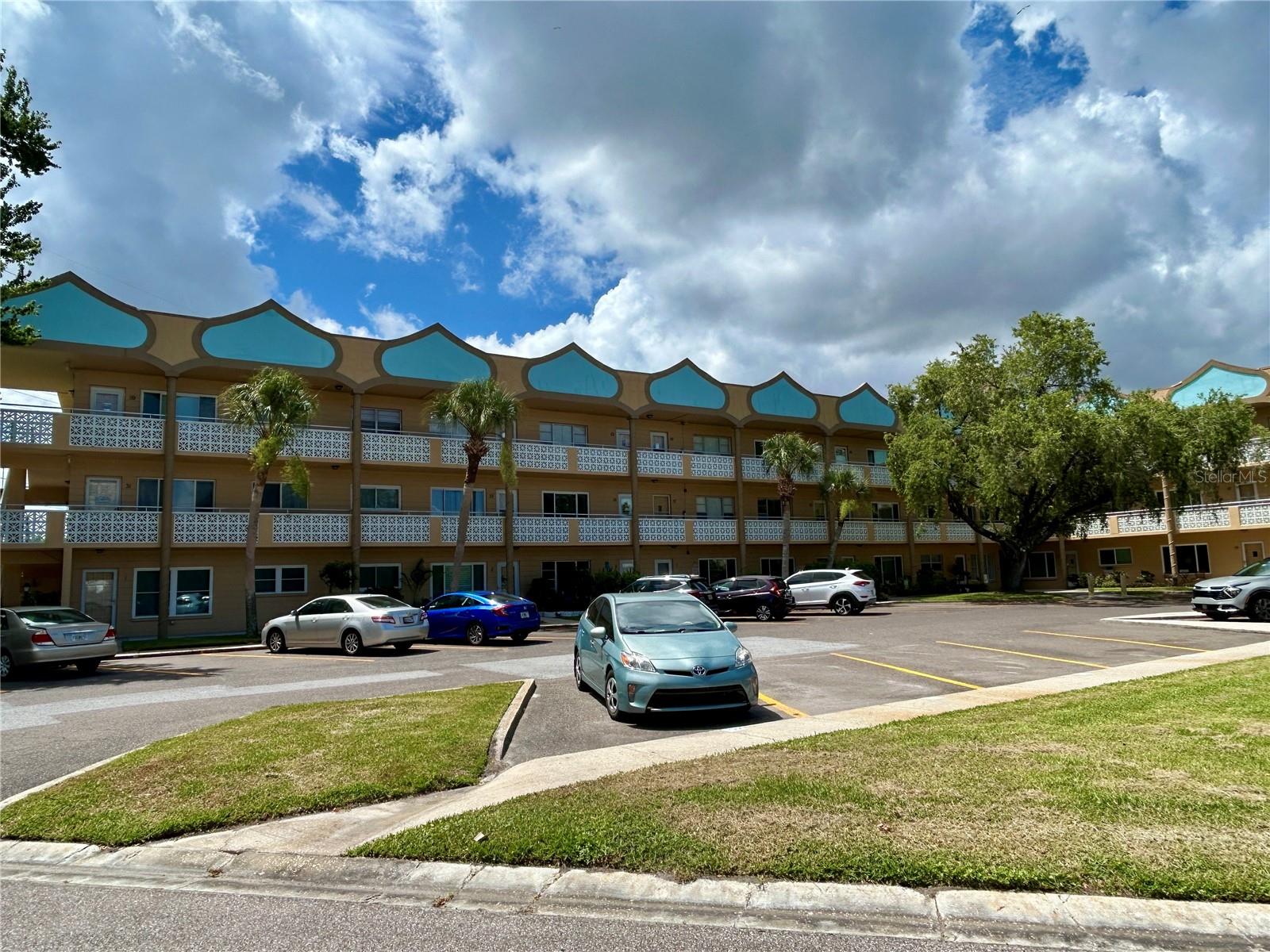 This first floor, furnished 2 bed 2 bath property is an ideal blend of comfort and convenience! Situated on a quiet cul-de-sac directly across the street from one of two private golf courses, you will have convenient access to amenities including a heated swimming pool, modern fitness center, tennis, and pickleball courts, all within walking distance. Park in your assigned parking spot, conveniently located right outside your front door. As you step inside, you will be greeted by beautiful laminate flooring extending throughout the unit. No carpet here! The reconfigured kitchen has extended counterspace and extra cabinets, making this kitchen a true delight for anyone who enjoys cooking. Relax in the comfort and privacy of the primary bedroom with an updated en suite bathroom, including newer tilework, a vanity and commode. Enjoy the fresh air and shade while you relax under the awning on the rear patio. Key updates to keep you comfortable include replacement windows, ceiling fans in all the main rooms, and the HVAC that was replaced in 2019. Enjoy the convenience of your own washer and dryer, and the water heater was replaced in 2022. This vibrant 55+ community offers an array of amenities designed to enhance your lifestyle. Enjoy exclusive access to two private golf courses, two heated swimming pools, tennis and pickleball courts, and two activity centers. Stay fit with the remodeled Cardio Gym, equipped with the latest exercise equipment, or participate in various community activities such as fitness classes, dancing, clubs, cards, billiards, and more. Pet owners will appreciate the very pet-friendly environment, complete with a fenced dog park and covered seating. The community also offers hobby studios and a woodshop for the exclusive use of residents. The on-site Good Karma Cafe provides convenient hot and cold beverages and snacks. Located close to beaches, transportation, shopping, entertainment, and fine dining, this condo combines convenience with comfort. All room sizes, floor plans, and square footage are approximate. This property is being transferred by a leasehold estate deed, and association approval is required. If financing, a 35% down payment is required. Don't miss out on this fantastic opportunity to own a contemporary condo in a prime location. Schedule your showing today and envision yourself enjoying the best in comfortable and convenient living!
