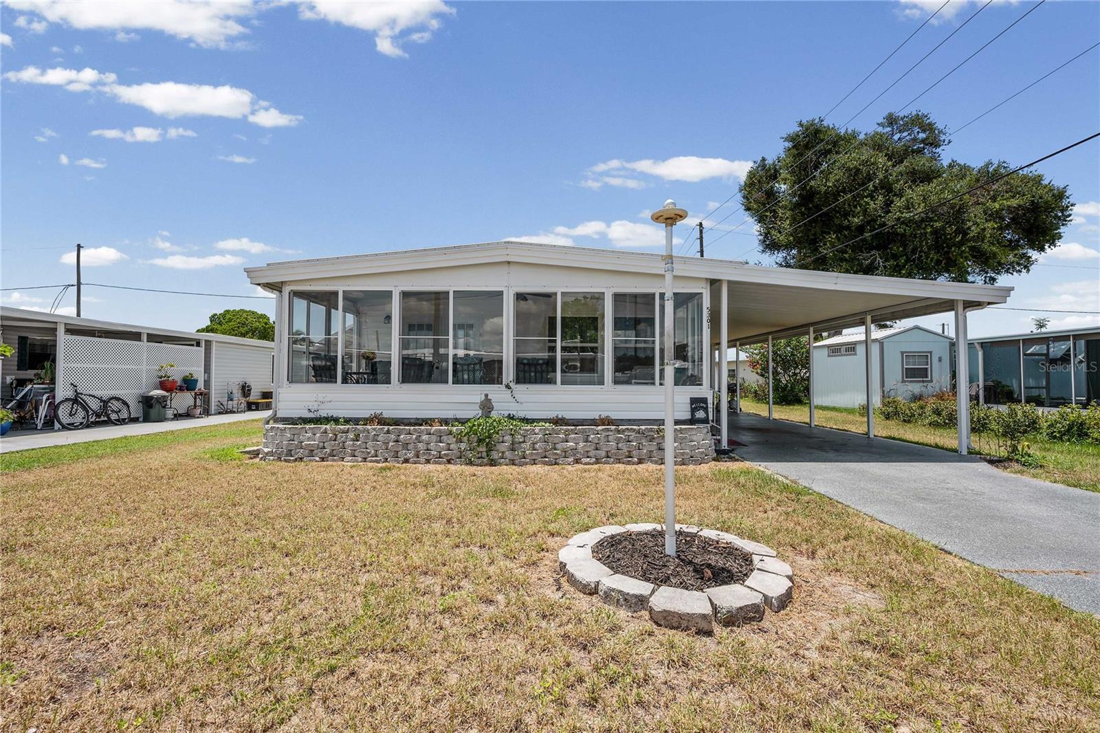 Welcome to 5301 Flint in the highly sought-after Betmar Acres 55+ community, where you own your land and enjoy an incredibly low annual fee of just $448! This well-maintained, move-in ready home offers comfort, updates, and flexibility—perfect for enjoying Florida living year-round or as your seasonal retreat.  Step inside and you’ll immediately notice the bright and inviting layout filled with natural light. The spacious living room spans the front of the home and flows beautifully into the dining area and kitchen, creating a comfortable space for relaxing or entertaining. The kitchen features painted wood cabinetry, a closet pantry, and a cozy eat-in area.  Just off the living room is the enclosed front Florida room—a wonderful bonus space with endless possibilities. Use it as a family room, hobby area, home office, additional guest space, or simply open the windows and enjoy the beautiful Florida breezes.  At the back of the home, you’ll find a generously sized primary suite with plenty of room for a king-size bed, featuring three closets, built-in drawers, and a private ensuite bath with a step-in shower. The guest bedroom easily accommodates a queen-size bed and is conveniently located near the second full bath, which also offers an updated step-in shower.  Additional features include luxury vinyl plank flooring throughout the home (with tile in the primary bath), double-pane vinyl windows, vinyl siding, and the convenience of being sold fully furnished for an easy transition. Even better—the seller is including the golf cart with the sale of this home!  Enjoy peace of mind with major updates already completed, including a 2024 membrane roof and 2023 A/C system. Outside, you’ll appreciate the attached laundry/storage area, welcoming front planter, and spacious backyard with room to garden, relax, or create your own outdoor retreat.  Located in Betmar Acres, residents enjoy an active lifestyle with access to three 9-hole golf courses, two swimming pools with hot tubs, pickleball, tennis, shuffleboard, clubs, events, and a full calendar of social activities.  With the updates completed, furnishings included, golf cart waiting, and a fantastic price—this home is ready for its next owner. Schedule your showing today and discover why so many love calling Betmar Acres home!