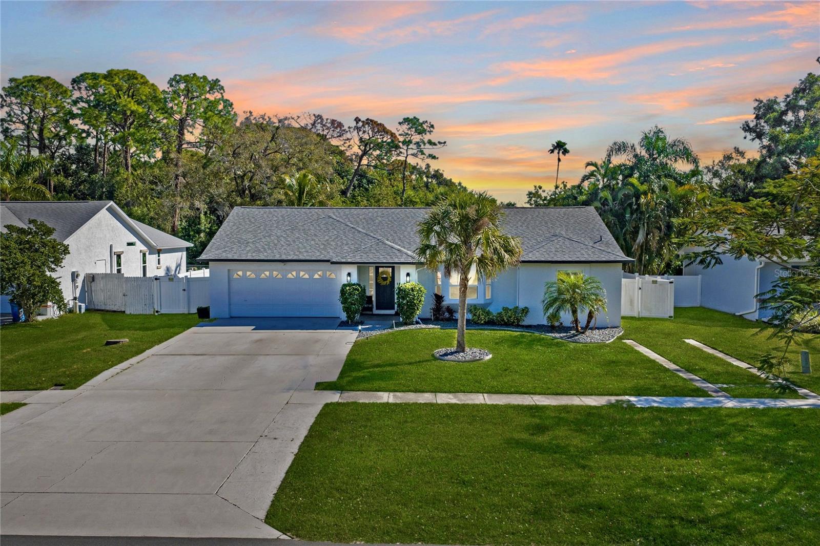 Welcome to 9693 58th St N in Pinellas Park—where space, style, and location come together in one incredible opportunity just 15 minutes from the Gulf beaches. This beautifully updated 3-bedroom, 2-bath home offers over 2,000 square feet of bright, open living space designed to impress from the moment you walk in. Soaring vaulted ceilings and sleek luxury vinyl flooring create a modern, airy feel throughout, perfectly complementing the fully renovated kitchen and spa-inspired bathrooms. The upgrades don’t stop there—enjoy an oversized, remodeled walk-in closet that adds both function and a touch of luxury to your daily routine. One of the home's most striking features is the entire rear wall lined with sliding glass doors, flooding the living spaces with natural light and creating a seamless indoor-outdoor feel. From nearly every room at the back of the home, you'll enjoy peaceful views of protected woodlands with no rear neighbors, offering rare privacy and tranquility that's hard to find in Pinellas County. Step outside and discover a backyard that truly sets this home apart. Sitting on nearly a quarter-acre, the fully fenced yard features a 6-ft white vinyl fence and backs up to protected woodlands—meaning no rear neighbors and lasting privacy you can count on. Whether you're entertaining, relaxing, or creating your dream outdoor space, this yard delivers. And here’s the bonus buyers are looking for: NO HOA and NO CDD. Bring your boat, RV, or toys—there’s room for it all right on your own property. Located in a non-flood zone with no history of water intrusion, this home offers peace of mind along with unbeatable convenience near Pinellas public schools, shopping, dining, and everything the area has to offer. Homes with this combination of updates, space, privacy, and freedom rarely last—don’t miss your chance to make it yours.