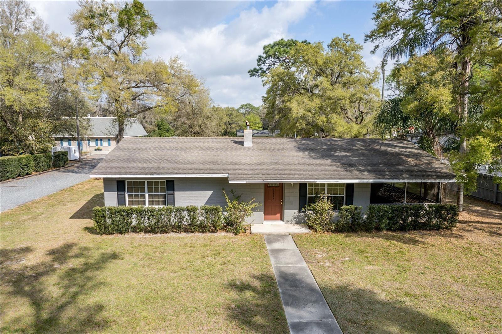 Opportunity awaits with this versatile 2-bedroom, 1.5-bath block home situated on a corner lot in the Sorrento/Mt. Plymouth area. The property is currently being used for residential purposes but is zoned commercial, offering flexibility for a variety of potential future uses, subject to applicable zoning and county requirements. Located just one block from Sorrento Avenue, it provides convenient access and visibility while still offering the comfort of a residential setting. The home features generously sized bedrooms, a functional layout, and a 12-by-20 fully screened carport that provides additional space for parking, relaxing, entertaining, or other uses. A detached well house offers useful dry storage or potential workspace. Whether you are searching for a residence, an investment opportunity, or a commercially zoned property with future possibilities, this unique offering deserves a closer look.