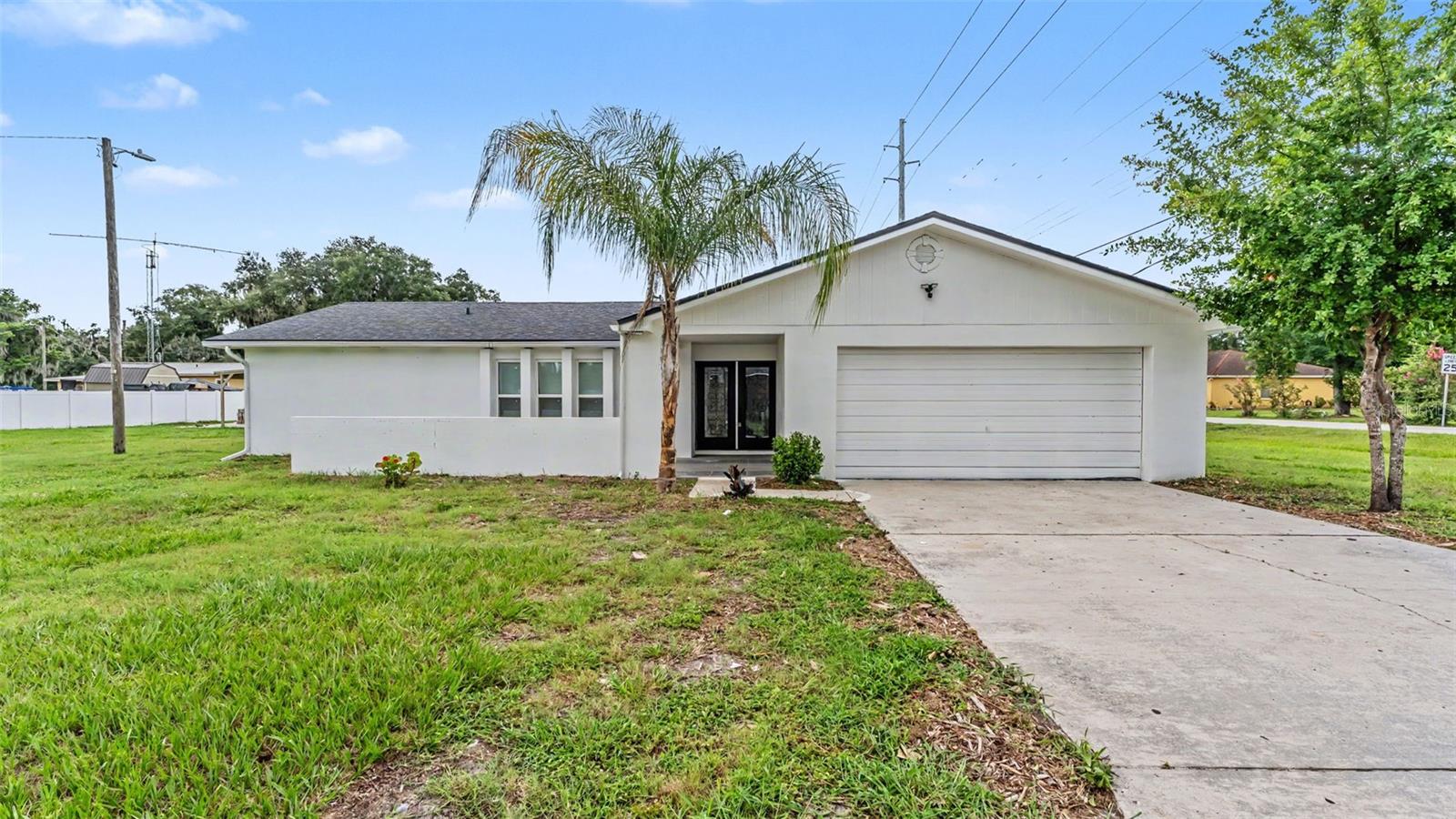 Don't miss out on this completely remodeled home in Mulberry! This home features 5 Bedrooms and 2 Bathrooms on a lot that has plenty of space and an additional 2 car carport for parking a workshop etc. Tile flooring throughout the home with new paint inside and out, countertops, lighting and much more! A separate living and family room, fireplace, screened in back porch and irrigation well are just a few of the additional features this home has. Also included are a brand-new AC, and roof which will help with your homeowner's insurance rate. Did we mention NO HOA! Seeing is believing with this large family home!
