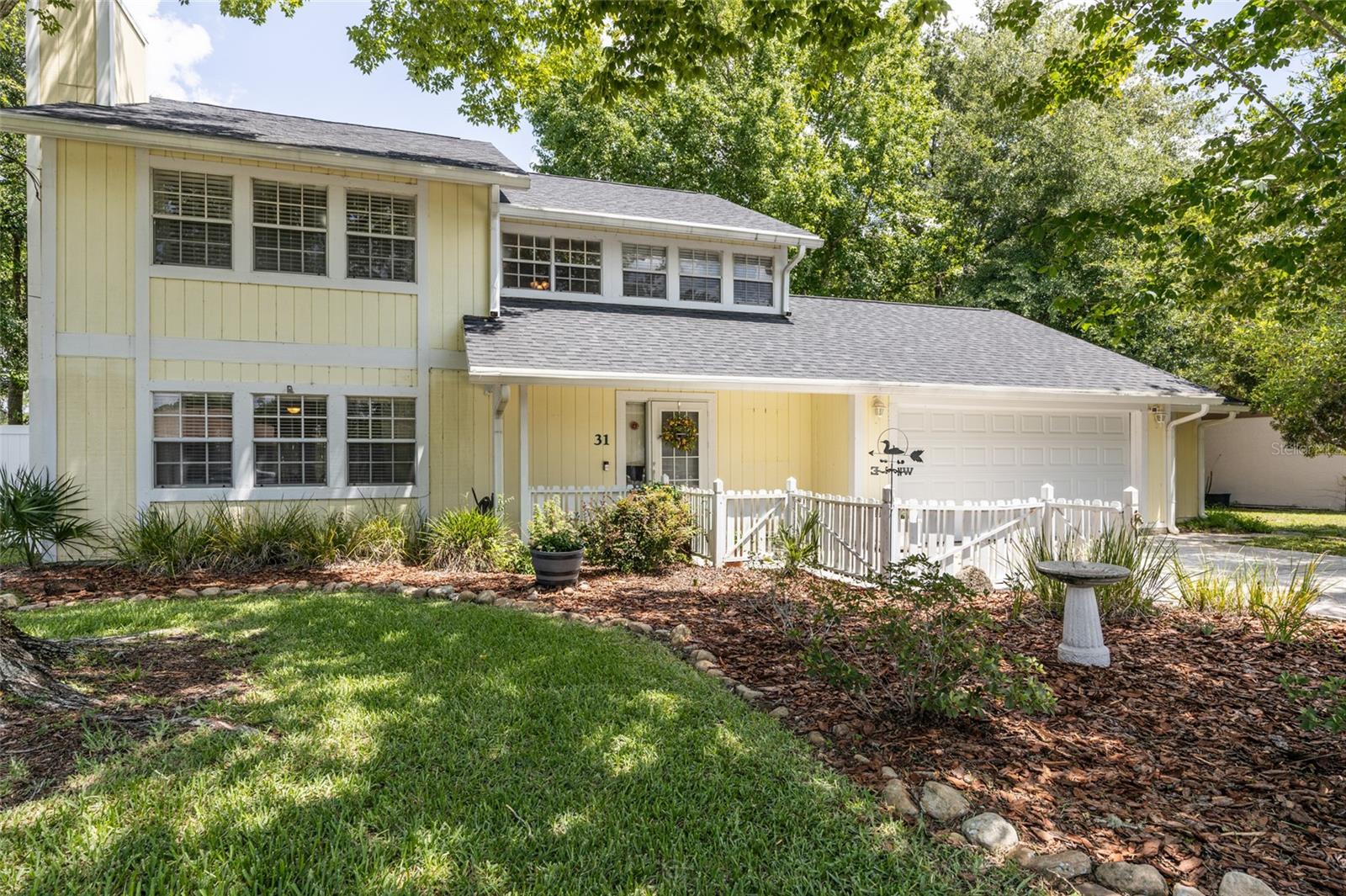 Welcome to this beautiful 3-bedroom, 2.5-bathroom Colonial-style home nestled in the highly desirable Pine Lakes subdivision. Built by Palm Coast Construction on a 0.24-acre lot, this 1,845 sq. ft. residence offers a functional layout and distinct architectural details. From the pale-yellow wood siding to the fenced front courtyard entry, this property provides excellent curb appeal.  

Interior & Living Spaces: The main level features an inviting flow with a combination of laminate, ceramic tile, and carpet flooring. The open kitchen is a chef's delight, complete with solid wood cabinetry accented by glass-front upper doors, a full stainless-steel appliance package (range, microwave, refrigerator, and dishwasher), and a multi-level island with a breakfast bar that opens directly to the family room and den areas. The spacious living room is highlighted by a cozy tile-surround fireplace, and custom floor-to-ceiling wood built-ins. Adjacent to the kitchen, the bright dining area features classic French doors that open out to the backyard patio.  

Upper-Level Accommodations & Bonus Space: All bedrooms, including the spacious primary bedroom suite, are located on the second floor to maximize privacy from the main living spaces. The home is equipped with a heat pump and a zoned central air conditioning system for energy-efficient, year-round temperature control. This climate-controlled system also extends to a dedicated private office space, conveniently accessed directly from the garage.  

Outdoor Features & Bonus Structures: The private backyard serves as a true outdoor retreat perfectly designed for recreation and utility. Enjoy sunny days cooling off in the in-ground pool, which is surrounded by a spacious patio and rear porch area, or relax under the shade of three beautiful pergolas. For extra utility, the home features a 10x10 built-in shed situated directly behind the office space, alongside a spacious attached 2-car garage providing ample space for parking and storage.