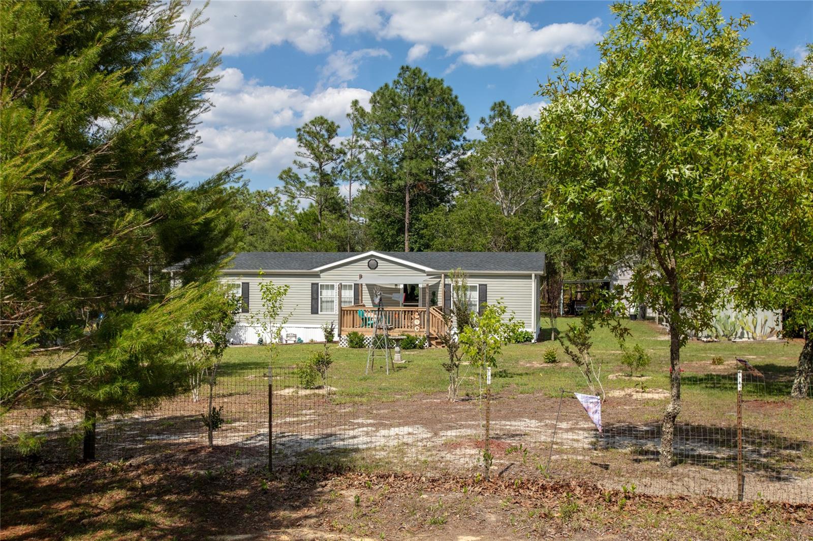 Welcome to 5670 Acadia in Keystone Heights, FL! This 3-bedroom, 2-bath home offers the perfect blend of comfort, updates, and outdoor space on 4 fully fenced acres. Inside, the primary bathroom features both a shower and garden tub, while the home also includes updated flooring and appliances from 2019. Major improvements include a new roof in 2025 and new skirting in May 2026. Outside, this property is packed with features--an above-ground pool, 3 patios, 2 drive-through gates, and parking for 5 vehicles. There's also a charming insulated she shed with drywall interior, ideal for hobbies, storage, or a creative workspace. The land is filled with fruit trees and flowering vines, including peach, guava, Meyer lemon, kumquat, navel orange, passion fruit, and hummingbird vine. This property offers space, privacy, and plenty of room to enjoy Florida living. Added bonus is porches on both front and back. Easy commute to Jacksonville, Gainesville and Palatka.