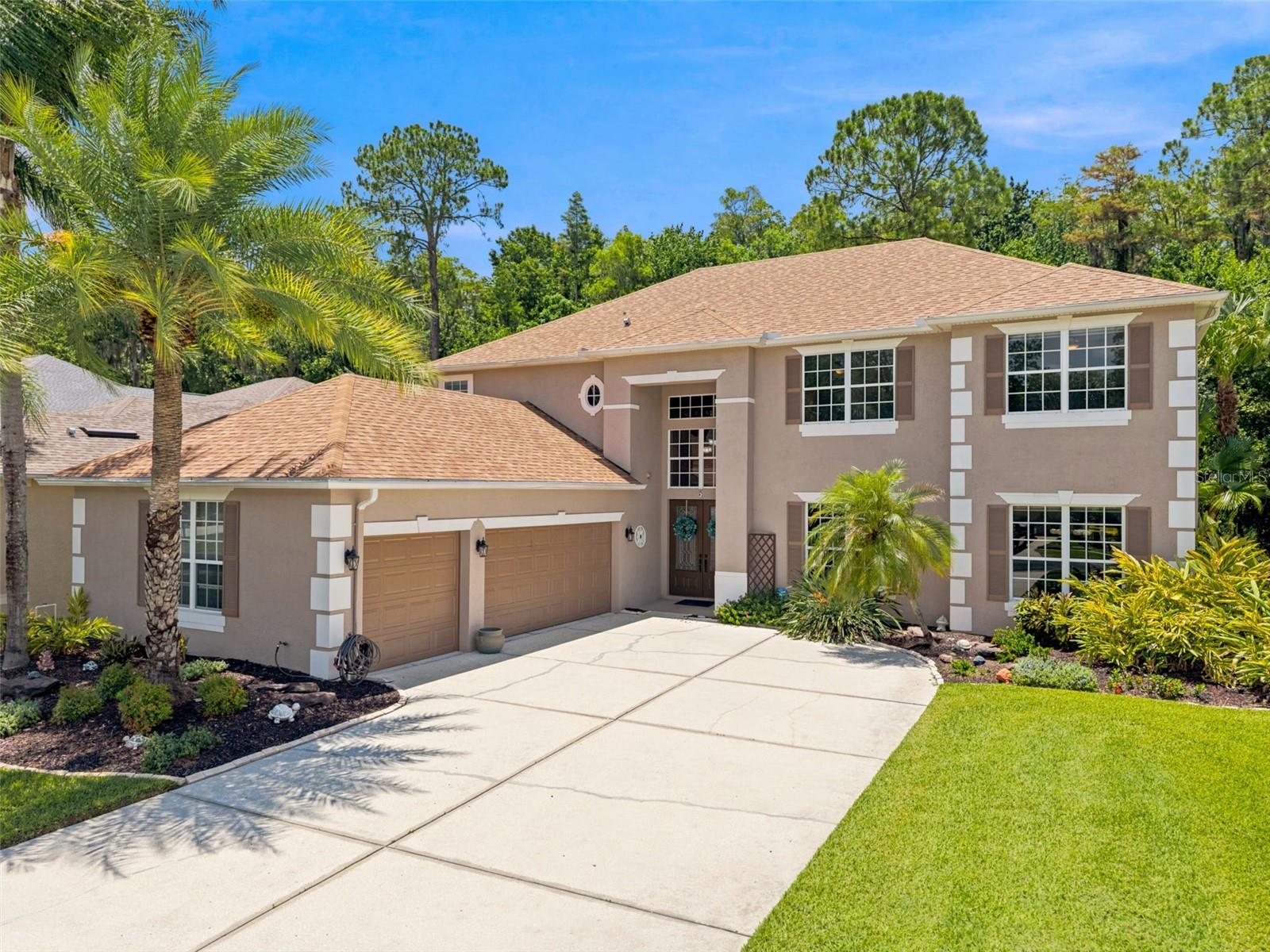 Welcome to an exceptional gated pool residence in Shoregrass at Seven Oaks, where grand scale, thoughtful design, and private conservation views create a true Florida retreat. With 6 bedrooms, 4.5 baths, a bonus media room, pool and spa, and a highly desirable two-bedroom-downstairs layout, this home offers the rare combination of flexibility, privacy, and elevated everyday living. From the moment you arrive, the home makes a statement with impressive curb appeal, manicured landscaping, rain gutters, and a welcoming entry. Inside, natural light fills the dramatic two-story living spaces, highlighting the architectural details, open sightlines, ceramic wood-look tile flooring throughout the main living areas, and an elegant staircase finished with wrought-iron spindles. Designed to bring people together, the expansive kitchen serves as the heart of the home with granite countertops, abundant cabinetry, a center island, cooktop, wall oven, breakfast bar, and generous casual dining space. The kitchen opens naturally to the family room and outdoor living area, creating an ideal setting for entertaining, holidays, and relaxed evenings at home. The first-floor primary suite provides a private retreat, while a secondary bedroom downstairs with its own nearby full bath offers ideal flexibility for guests, multigenerational living, a private office, or a nursery. Upstairs, four additional bedrooms, well-appointed baths, and a spacious bonus media room provide room for everyone to spread out—whether used as a home theater, game room, lounge, study space, or playroom. Outside, the screened lanai is the ultimate extension of the home. Enjoy a sparkling pool and spa overlooking peaceful conservation, with no rear neighbors and a tranquil natural backdrop that makes every day feel like a getaway. This private outdoor setting is ideal for morning coffee, weekend entertaining, and unwinding at the end of the day. Additional highlights include three air-conditioning systems, abundant storage, and a floor plan that balances impressive entertaining spaces with the comfort and privacy.
Located within the gated Shoregrass section of Seven Oaks, residents enjoy the security of a gated enclave along with access to the community’s sought-after resort-style amenities, including clubhouse facilities, pools, fitness center, sports courts, playgrounds, trails, and community events. Conveniently positioned near The Shops at Wiregrass, Tampa Premium Outlets, dining, medical facilities, major roadways, and highly regarded schools. A rare opportunity to own a private conservation pool-and-spa home with six bedrooms, a media room, and exceptional flexibility in one of Wesley Chapel’s most desirable communities.
