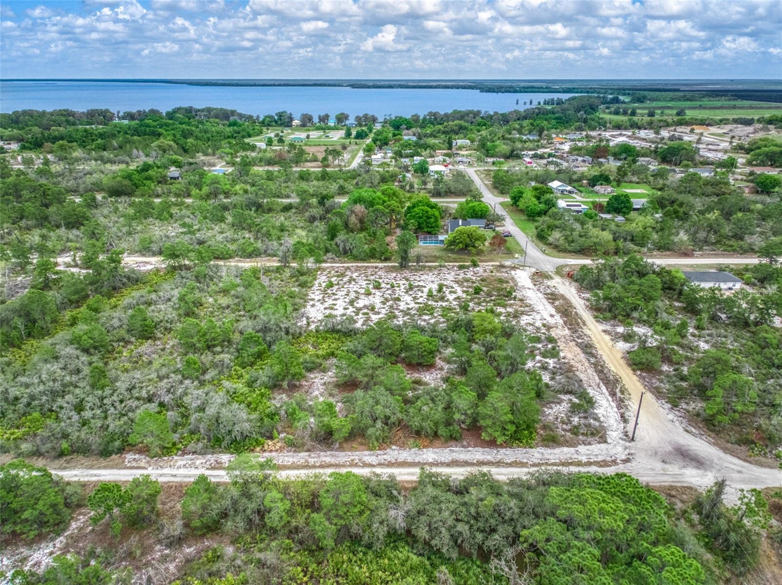 This is a double parcel lot that was combined equaling just over a half acre on a corner lot. The perfect place to build your dream home. The location offers a peaceful small-town feel, with a close-knit community. Lake Placid is often described as "Florida's best-kept secret. Everything from shops, restaurants, and events that celebrate the area's heritage, enhancing its appeal for buyers seeking a quieter lifestyle. Lake Placid, Florida, is famously known as the "Caladium Capital of the World" producing approximately 98% of the worlds caladium bulb. Its also known as the "Town of Murals". The murals depict local history and culture that add a unique artistic flair to the community. The annual Caladium Festival in June is a major event, drawing visitors for flower-related activities. Nestled among dozens of lakes, popular spots include Lake June-in-Winter Scrub Preserve State Park for hiking and birding, and Lake Istokpoga for world-class bass fishing.

For more extensive amenities, Sebring is about 10 miles away, offering larger shopping centers, hospitals, and entertainment options, including the Sebring International Raceway, known for its car races at Sebring International Raceway
