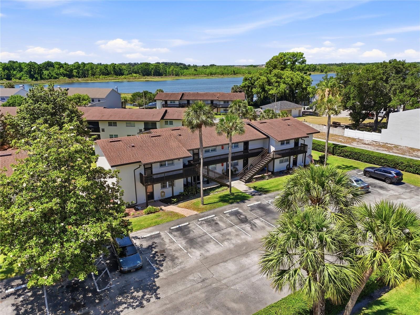 Condo located in Winter Haven FL, the Water Ski Capital of the World and only 6 minutes from Legoland! Ground-floor, furnished condo in Sandy Cove, a lakefront community on the beautiful Winter Haven Chain of Lakes. This furnished 2-bedroom, 1-bath unit offers low-maintenance living that’s ideal for full-time residents, seasonal owners, retirees, or anyone seeking a convenient Florida lifestyle. The layout offers comfortable living with a spacious great room featuring laminate flooring, a ceiling fan, and sliding doors leading to the enclosed Florida room. The adjacent dining space is cozy and ideal for entertaining or quiet nights in. The kitchen is complete with quartz countertops, included appliances, and a stackable washer and dryer. The unit also features double-pane windows for improved energy efficiency, comfort, and noise reduction. The primary bedroom is generously sized and features a ceiling fan, walk-in closet, and direct access to the bathroom. The guest bedroom is also comfortably sized with a built-in closet, ceiling fan, and en-suite-style bathroom access. The bathroom has been updated with an upgraded vanity, solid-surface countertop, and walk-in shower. Enjoy outdoor living from the enclosed Florida room with screens and vinyl windows, perfect for relaxing or entertaining year-round. This ground-floor unit is ideally positioned just steps from the community clubhouse, grill area, and heated pool maintained at approximately 85 degrees for year-round enjoyment. Sandy Cove also offers a community dock on Lake Lulu, one of twenty+ lakes on the Winter Haven Chain, providing a peaceful setting to unwind, enjoy waterfront views, and take in beautiful Florida sunsets. Residents enjoy the relaxed lifestyle that makes Winter Haven so desirable, including boating, fishing, lakeside dining, golf courses, walking paths, and year-round community events. Conveniently located near everyday essentials and recreation, the condo is just minutes from Publix Super Markets, CVS Pharmacy, restaurants, banks, medical offices, and Walmart shopping. Nearby public boat access on Lake Summit makes it easy to enjoy the Chain of Lakes lifestyle, while several local golf courses are only a short drive away. The location also provides convenient access to both Orlando and ,making this an excellent choice for easy, low-maintenance Central Florida living.