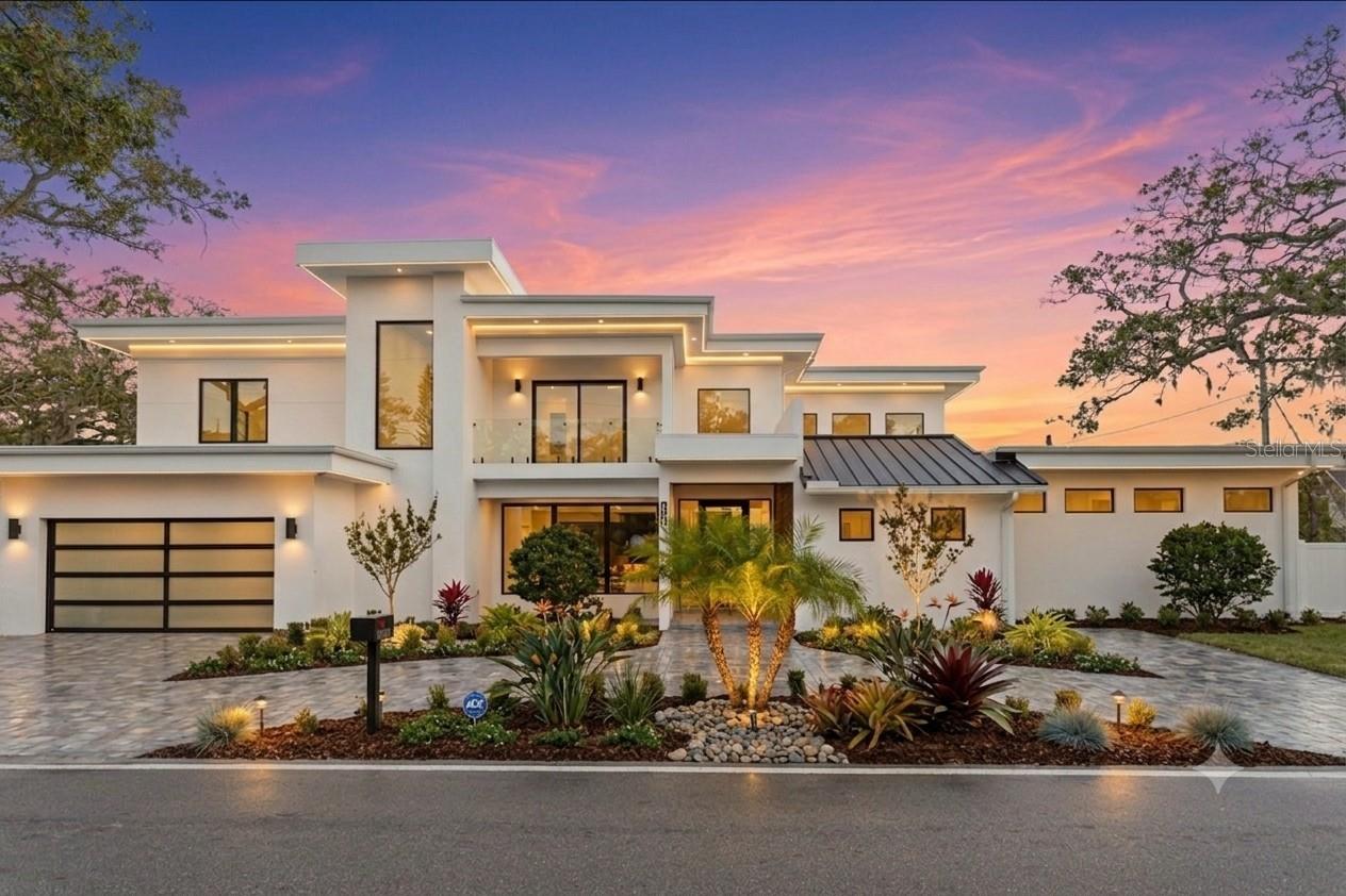 2089 Arlington Street, where architecture meets light, space, and coastal elegance, this newly constructed contemporary residence offers 4,231 square feet of living space and 5,284 total square feet, thoughtfully designed with architectural precision and warm minimalism. Completed in January 2026, this striking two-story home sits on a rare double corner lot and features 5 bedrooms and 6 bathrooms, delivering both scale and sophistication.
The open-concept interior is defined by dramatic 22-foot ceilings, expansive custom windows and doors, and an abundance of natural light throughout. The main level is anchored by a statement chef’s kitchen imported from Italy, showcasing custom cabinetry, luxury built-in appliances, a Sub-Zero refrigerator, premium hardware, and top-quality London Fog granite countertops. A concealed secondary kitchen provides additional functionality and discretion, ideal for entertaining and catered events.
The primary suite is conveniently located on the ground floor, offering a private retreat with serene views and a spa-inspired bath. Additional bedrooms are generously sized, each with access to a full bathroom. A custom glass wine room adds a refined architectural focal point, while a loft-style family/media lounge on the second level overlooks the main living area, enhancing the home’s open, airy feel.
Designed for seamless indoor–outdoor living, oversized sliding doors open to a private resort-style setting with a custom pool and spa, covered terrace, and enhanced landscaping. Architectural exterior lighting highlights the home’s clean lines and modern façade after sunset.
Quality and performance are paramount: both levels are constructed of solid concrete block, and three independent HVAC systems serve the ground floor, primary suite, and second floor for optimal comfort and efficiency. Additional features include a private elevator, and all custom-made windows, doors, and cabinetry throughout—evidence of meticulous attention to detail in every finish.
Ideally located for effortless travel and coastal lifestyle enjoyment, this home is approximately 12–15 minutes from Sarasota–Bradenton International Airport, about 1 hour 10 minutes from Tampa International Airport, 10–15 minutes to Lido Key, and about 15 minutes to Siesta Key, world-renowned for powder-white sand and Gulf sunsets.
Situated outside of a flood zone, this exceptional residence presents a rare opportunity to own a custom-built contemporary home where design, craftsmanship, location, and lifestyle converge.
