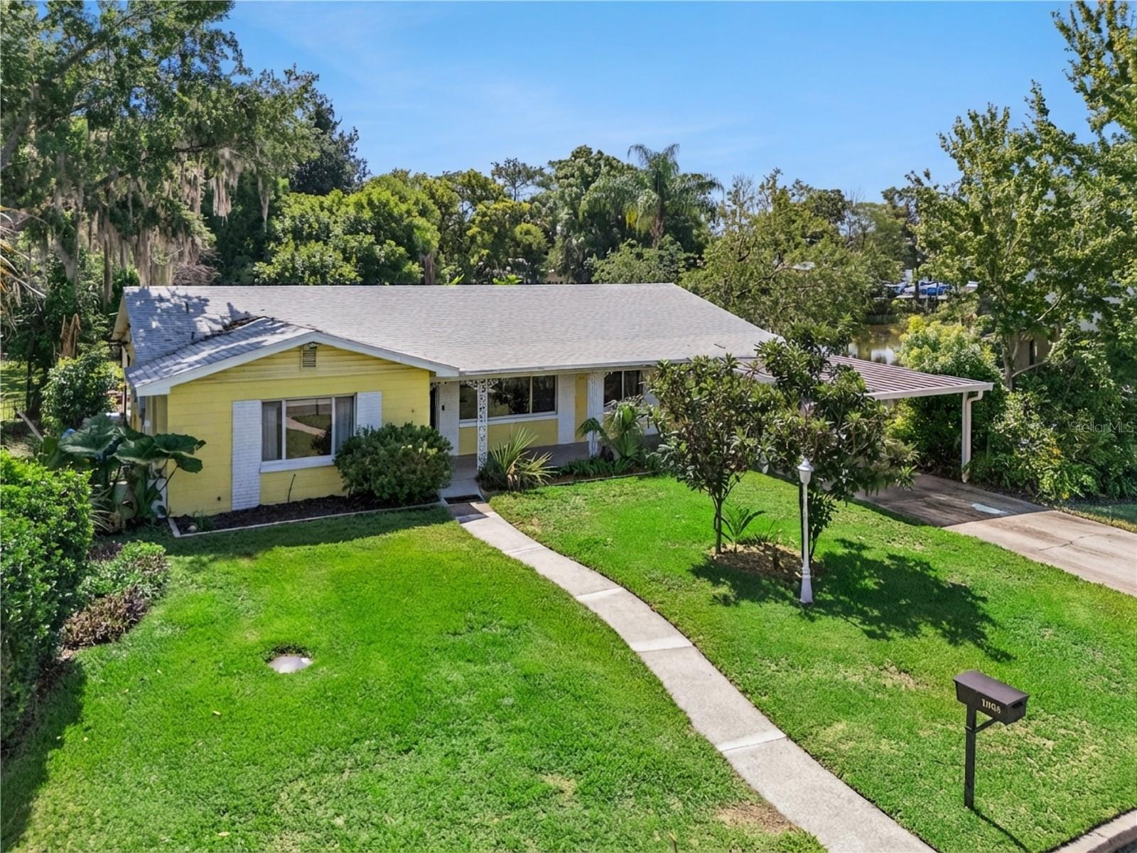 Rare Waterfront Opportunity in Winter Park! Discover your own slice of Florida paradise with this waterfront gem offering 94 feet of direct canal frontage on Lake Bell for under $600,000. Tucked away in a peaceful, private setting, yet just minutes from Winter Park’s famed Park Ave, Winter Park Village, College Park and Downtown Orlando with numerous shopping and dining options making this property the perfect blend of seclusion and convenience. Built in 1957, this classic Florida ranch features 3 bedrooms and 2 bathrooms within 1,837 SF of living space.  Major updates include a new roof in 2024 and HVAC in 2019. Step inside off the covered front porch to find spacious living and dining areas highlighted by charming built-in features and abundant natural light. At the heart of the home, the kitchen offers easy access to a generous walk-in pantry/utility room/laundry area. The adjoining family room opens to a covered back porch overlooking the expansive backyard and tranquil canal. Situated on a .40-acre lot, the property extends beyond the canal, creating a natural wooded buffer that enhances privacy and provides a serene backdrop. Whether you envision a pool, outdoor kitchen, garden, or entertaining space, the backyard offers endless possibilities to create your dream outdoor oasis (subject to municipal review and approvals). Lake Bell is a 36-acre spring-fed ski lake with an average depth of 12 feet, ideal for boating, skiing, kayaking, paddle boarding and enjoying the Florida lifestyle. Fishing enthusiasts will also appreciate the lake’s reputation for largemouth bass and bluegill. Other notable exterior highlights include fenced in backyard, covered front entry, two rear porches and 1-car carport.  The home is on septic that has been well maintained and serviced annually.  The location also offers quick access to Interstate 4 and close proximity to area hospitals, parks and cultural centers.  Don’t miss this exceptional opportunity to own waterfront property in Winter Park/3789 at an incredible value!
