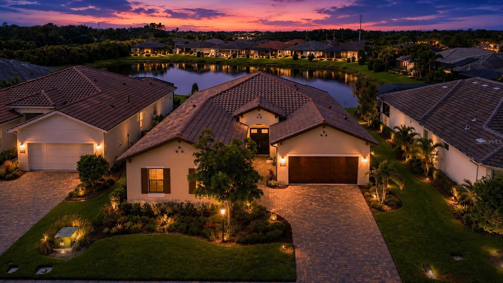 STUNNING LAKEFRONT HOME IN MAINTENANCE-FREE GATED COMMUNITY.  Enjoy luxury lakefront living in this beautifully appointed 3-bedroom, 3-bath home with a den/office and 3-car garage, located in the sought after maintenance-free gated community of Sandhill Lake. This open-concept home features 10-foot ceilings with elegant tray and coffered details, plantation shutters throughout, impact windows, a whole-house Generac generator, paver driveway, and natural gas service.
The chef's kitchen is the heart of the home, offering a gas range with range hood, oversized island, abundant cabinetry, and a large pantry, all overlooking the spacious great room and dining areas with beautiful lake views. Step outside to the expansive screened lanai and enjoy peaceful waterfront sunsets, with natural gas already available for your future outdoor kitchen or grill.
The lakefront primary suite is a private retreat featuring coffered ceilings, two walk-in closets, and en suite bath with dual vanities, separate sinks, and a walk-in shower. Two additional bedrooms - one with a private en-suite bath, a versatile den/office, and a spacious laundry room with utility sink provide exceptional comfort and functionality.
Residents enjoy resort-style amenities including a community pool, hot tub, and clubhouse. Conveniently located less than 2 miles from Twin Lakes Park, under 3 miles to I-75 for easy commuting, and just 8 miles from Siesta Key's world-renowned quartz sand beaches. This exceptional home combines quality construction, modern conveniences, and an unbeatable Florida lifestyle.