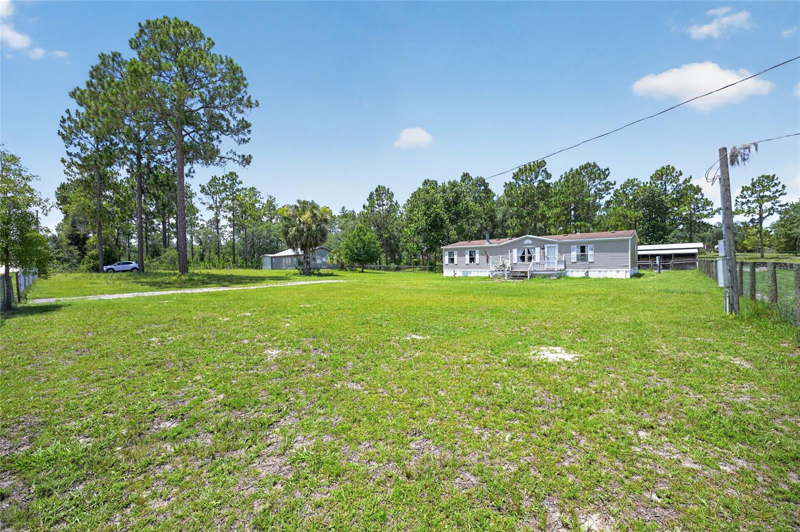 Income-Producing Horse Property!! Looking for a home with some acreage, a barn and a guest house? This is it, just a couple of miles from the Black Prong Resort!! Lovely spacious 2.58 acre corner-lot manufactured home has been well-maintained, 3 big bedrooms and 2 baths. Appliances are less than 3 years old, new garbage disposal (needs installation) washer and dryer convey.  The metal detached guest home has a living room/dining room, one bedroom and one full bath, kitchen and lots of storage! 2 Wall units for a/c.  There's also a really nice 2-stall barn with solar lights, all fenced and cross-fenced! Zoned Agricultural/Rural Residential,  Flood Zone X!!! Generator and zero point mower also available for sale separately.
