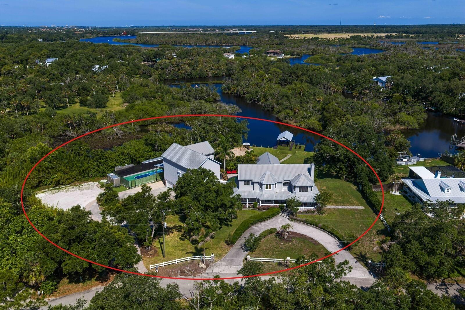 OVER $407,000 IN GROSS REVENUE GENERATED IN THE PAST 12 MONTHS WITH FUTURE BOOKINGS ALREADY ON THE CALENDAR!

Welcome to Shangri-La, an extraordinary private waterfront resort spanning over 3.6 acres along the scenic Manatee River. Fully furnished, turnkey, and operating as a successful luxury vacation rental, this one-of-a-kind estate presents a rare opportunity to acquire both a trophy waterfront compound and a proven income-producing asset. Recently appraised at $3,100,000, Shangri-La is offered at an exceptional value while generating more than $407,000 in gross revenue over the past 12 months. Having established itself as one of Florida's premier luxury vacation rentals, this remarkable property offers both an unparalleled lifestyle and a proven track record of performance. 

Offering over 7,100 square feet of air-conditioned space, this remarkable property features 9 bedrooms, 5.5 bathrooms, and accommodations for up to 25 guests spread across the main residence and a private accessory dwelling unit.

The outdoor amenities are exceptional. At the heart of the property lies a lagoon-style pool complemented by a custom rock waterfall and spa crafted by the renowned Lucas Lagoons team. Guests enjoy a covered waterfront pavilion with fire pit, private dock with jet ski access, a 20' x 40' tiki hut and tiki bar, outdoor kitchen, waterfront gazebo, private pickleball court, kayaks, paddleboards, and expansive grounds overlooking breathtaking Manatee River sunsets. Wraparound porches and a screened lanai provide the perfect place to relax and take in the views. The property offers parking for 30+ vehicles, an RV carport, and ample room for boats and trailers.

Inside, the main residence is designed for both entertaining and relaxation. The riverfront primary suite offers stunning water views and a spa-inspired bath. The chef's kitchen is fully equipped for large groups and is complemented by a commercial refrigerator and freezer. Additional amenities include a private steam room, infrared sauna, massage chair, and an ADA-compliant bedroom and full bathroom.

Recent improvements include updated pool equipment, newer HVAC systems, new Sealy Hybrid mattresses throughout, and a new 26.5 kW Generac whole-house generator capable of powering the property during outages.

Entertainment options abound with a dedicated home theater, expansive game room featuring billiards, shuffleboard, ping pong, poker, and arcade games, a private fitness room, and a recently added illuminated dance floor.

The private accessory dwelling unit contains two of the property's nine bedrooms along with a full bathroom and kitchenette, providing additional privacy and flexibility.

Included in the sale are approximately 25 tables, more than 100 chairs, approximately 15 kayaks and paddleboards with life jackets, gym equipment, a mower, a 36-foot enclosed cargo trailer, an estimated $50,000 in tools, maintenance equipment and replacement parts, plus a 2018 Forest River three-stall restroom trailer valued at approximately $60,000.

Conveniently located just minutes from Lakewood Ranch, IMG Academy, the Premier Sports Campus, and I-75, the property offers easy access to Tampa, St. Petersburg, Sarasota, and Florida's renowned Gulf Coast beaches.

Whether you're seeking a luxury waterfront retreat or a high-performing short-term rental investment with an established track record, Shangri-La represents a truly rare opportunity on Florida's Gulf Coast.