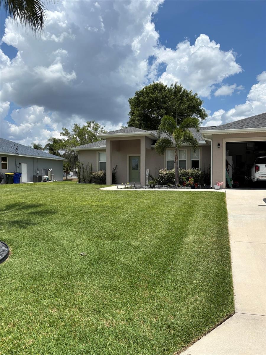 Lake living at its finest! This beautiful home, built in 2022, has been thoughtfully enhanced since its purchase in 2023. Enjoy direct lake access with a private boathouse and boat lift. The property features an expansive 10' x 55' screened rear porch, an 8' x 16' storage shed, a whole-home water softener system, faux wood blinds throughout, and a washer and dryer with upper and lower cabinetry. Recent exterior painting adds to the home's appeal. An additional concrete parking pad provides extra space for vehicles, a boat, recreational equipment. Don't miss this opportunity to enjoy waterfront living with modern upgrades and amenities.