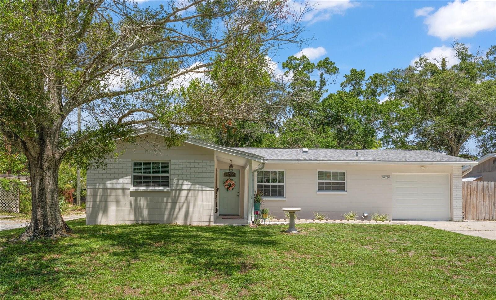 From the moment you arrive, this charming St. Petersburg home welcomes you with inviting curb appeal, a majestic shade tree, and a picturesque front walkway that sets the tone for the warm and inviting interior. Inside, an open, light-filled floor plan creates an effortless flow for everyday living and entertaining. The beautifully renovated kitchen is the heart of the home, featuring timeless white shaker-style cabinetry, gorgeous quartz countertops, stainless-steel appliances, stylish pendant lighting, and a breakfast bar, making it easy to stay connected with family and guests. Desirable split bedroom plan includes a generously sized primary suite providing a peaceful retreat with its private ensuite bath, while the additional bedrooms are bright and comfortable, offering plentiful closet space and easy access to a well-appointed hall bath with a tub/shower combo. Step outside to a private backyard designed for enjoying Florida's beautiful year-round weather, with plenty of room to dine outdoors, entertain friends, play with pets, or simply relax in your own outdoor oasis. Conveniently located near shopping, popular restaurants, award-winning Gulf beaches, vibrant downtown St. Petersburg, and two international airports, this move-in-ready home offers the perfect combination of comfort, style, and an exceptional location.