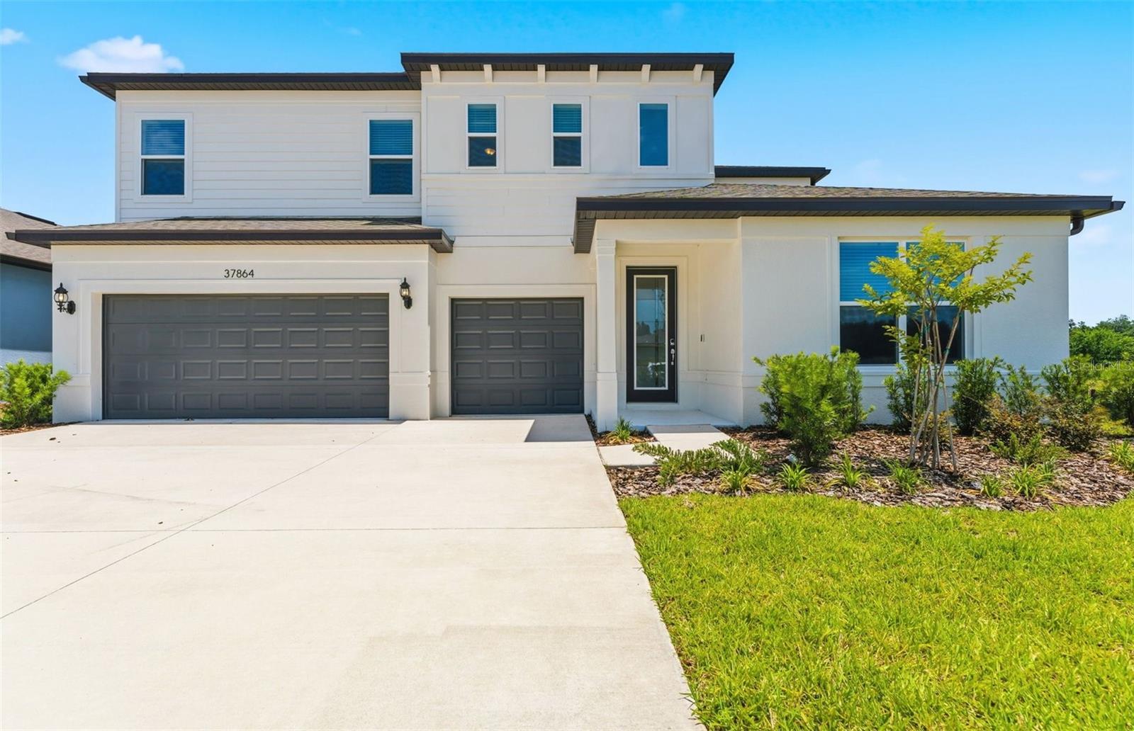 One or more photo(s) has been virtually staged. Move In Ready and Available NOW on private conservation homesite! Offering limited-time incentives and below-market rates! Pulte Homes is now selling in Riverwood, offering the rare opportunity to enjoy all the benefits of a new construction home in a highly amenitized Wesley Chapel community. This vibrant neighborhood features a lifestyle director, resort style pool with open cabana, clubhouse, fitness center, nature trails, shared green spaces, pickleball courts, a screened in game room, and a dog park-everything you need for a connected, active lifestyle. This consumer inspired Merlot home design provides the spacious layout, highlighted by a gourmet kitchen with a large center island, 50/50 stainless steel sink, stylish cabinetry, 3cm quartz countertops, 3”x12” tiled backsplash, spacious pantry, and Whirlpool stainless steel appliances including a refrigerator, dishwasher, built in oven and microwave, and gas stovetop with range hood. The bathrooms feature matching cabinetry and quartz countertops, with the Owner’s bath offering a walk in shower, private commode, and dual sinks. Durable 9”x36” tile flooring extends through the main living areas, baths, and laundry room, while stain resistant carpet adds comfort to the bedrooms and loft. This home is thoughtfully designed with a first floor Owner’s suite featuring a large retreat area and walk in closet, an enclosed flex room, a second story loft, a private full bath off the third bedroom, a convenient laundry room, a 3 car garage with epoxy flooring, and a spacious covered screened lanai. Additional upgrades include a pocket sliding glass door at the gathering room, tray ceilings in the Owner’s suite, gathering room, and flex room, a glass insert front door, LED downlights, a floor outlet, whole house faux wood blinds, and a Smart Home technology package with video doorbell. Enjoy peace of mind with Pulte’s transferable, 10-year Limited Structural Warranty that covers materials and workmanship in the 1st year, workability of plumbing, electrical, HVAC, and other mechanical systems through the 2nd year, various types of water infiltration and internal leaks through the 5th year, and the structural integrity of the home through the 10th year.