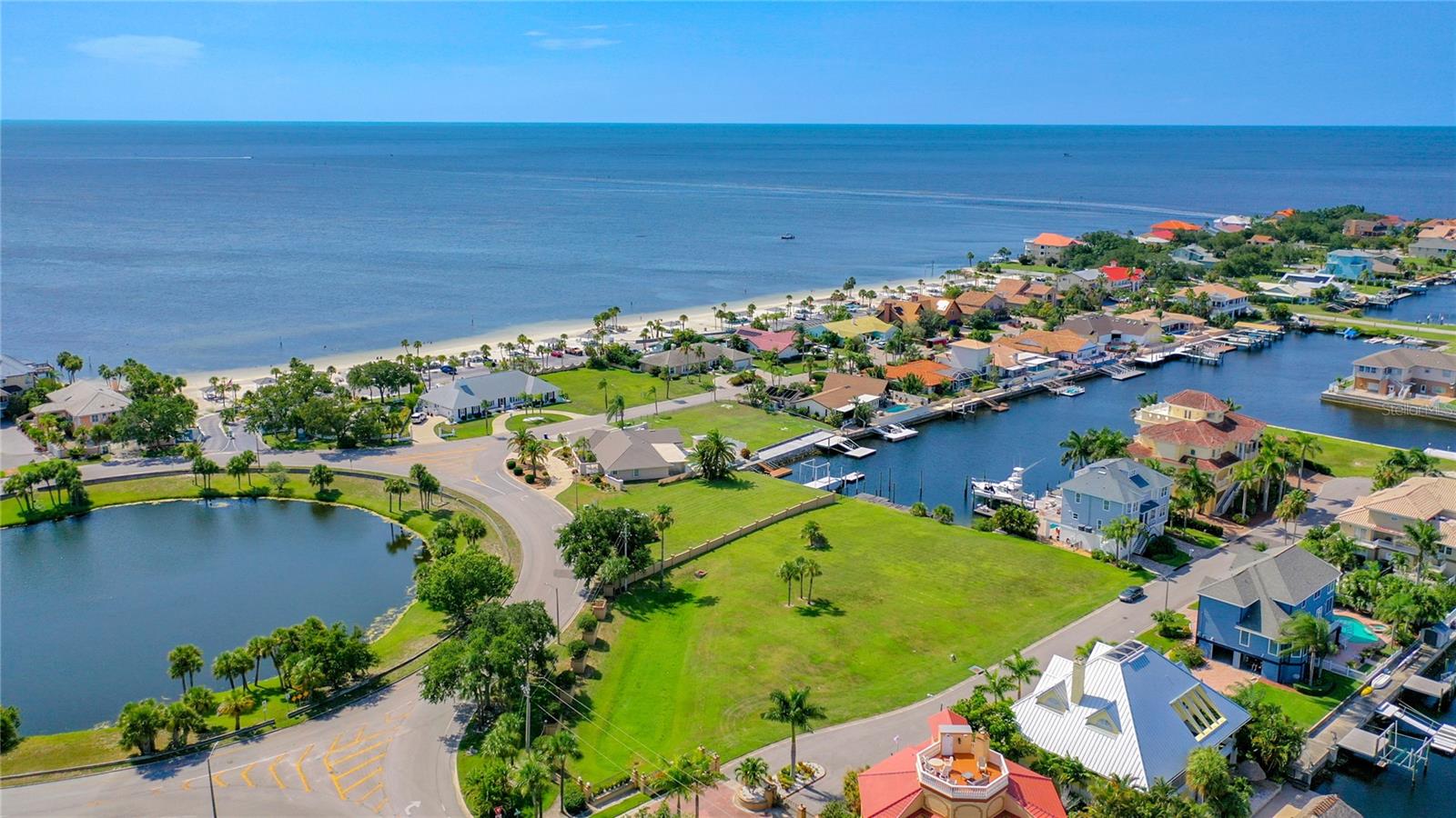 Oversized Waterfront Lot Seconds from Open Gulf Water!  Rare offering at almost 3/4 acre. This is one of the few gated communities in the area. Not to mention, just steps to private Beach Club where you can take-in the nightly sunset . There is nothing else like it in the area! Waterfront of this size does not come along very often. Flat buildable, oversized lot in gated Schooner Place neighborhood of Gulf Harbors. Build your dream-home and have possible Gulf views from 2nd and 3rd floors and possible 360 views if you build a rooftop deck! Existing 50-foot dock and additional pilings in place. Just add lift! Plenty of room for your boat, jet skis, floating dock and other waterfront toys! Just steps outside Schooner Place is the jewel of Gulf Harbors -- the private, residents-only beach club. The beach club is the best deal in town with a generously sized private beach with parking, cabanas, grills, restrooms, etc. It is a hub of neighborhood activities and events including corn-hole, volleyball, beach parties and more. Stop dreaming and start living the FL lifestyle to the fullest today.