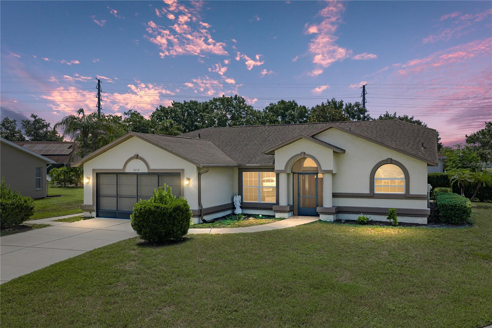 Welcome to Silver Oaks, one of Zephyrhills' most desirable golf course communities! This 3-bedroom, 2-bath home is situated on an oversized corner lot and offers comfortable living space with a bright, open layout and soaring vaulted ceilings. Step inside to find a spacious formal living and dining area with beautiful wood-look flooring, creating a warm and inviting first impression. The centrally located kitchen features abundant cabinetry, generous counter space, a breakfast bar, pantry, and overlooks the main living areas—perfect for everyday living and entertaining. The split-bedroom floor plan provides privacy, with a spacious primary suite offering vaulted ceilings, private access to the screened lanai, dual vanities, a walk-in shower, and an oversized walk-in closet. Two additional bedrooms and a full guest bath are thoughtfully located on the opposite side of the home. Enjoy year-round Florida living from the expansive screened lanai, providing the perfect space for morning coffee, relaxing evenings, or entertaining guests. The oversized corner homesite offers additional yard space, mature landscaping, and excellent curb appeal. Additional features include an indoor laundry room with storage, a two-car garage. Silver Oaks is a well-established golf course community with low HOA fees, mature oak trees, and convenient access to shopping, dining, medical facilities, schools, and major highways. Don't miss your opportunity to own this spacious home in one of Zephyrhills' most sought-after neighborhoods!