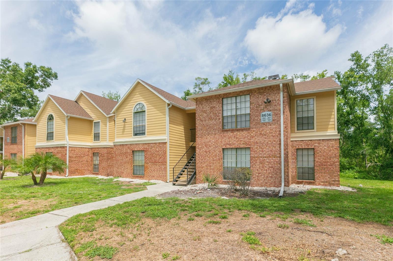 Great opportunity to own a beautiful condo in the heart of Tampa! Centrally located about five miles west of the University of South Florida, Busch Gardens, Moffitt Cancer Center, and Adventure Island, this property offers convenient access to local dining, schools, entertainment, shopping, and medical centers. This desirable corner unit features a split-floor plan with high ceilings, fresh paint, and a brand-new electrical panel. The spacious living room includes large windows and a cozy fireplace. The updated kitchen boasts stainless steel appliances, granite countertops, white shaker cabinets, and new light fixtures. Adjacent to the kitchen is a convenient indoor laundry closet equipped with a washer and dryer. Both bedrooms feature walk-in closets, and both bathrooms have been updated with brand-new vanities, lighting, and mirrors. Situated on the second floor, the condo includes a spacious balcony with a storage room, recently updated and painted waterproof deck wood flooring, and peaceful views of the surrounding mature landscaping. Located within a gated community, residents can enjoy premium amenities including a clubhouse, swimming pool, spa, gazebo, cabanas, fitness center, lighted tennis courts, and walking trails. Perfect as a primary residence or a rental investment property. Schedule your private showing today!