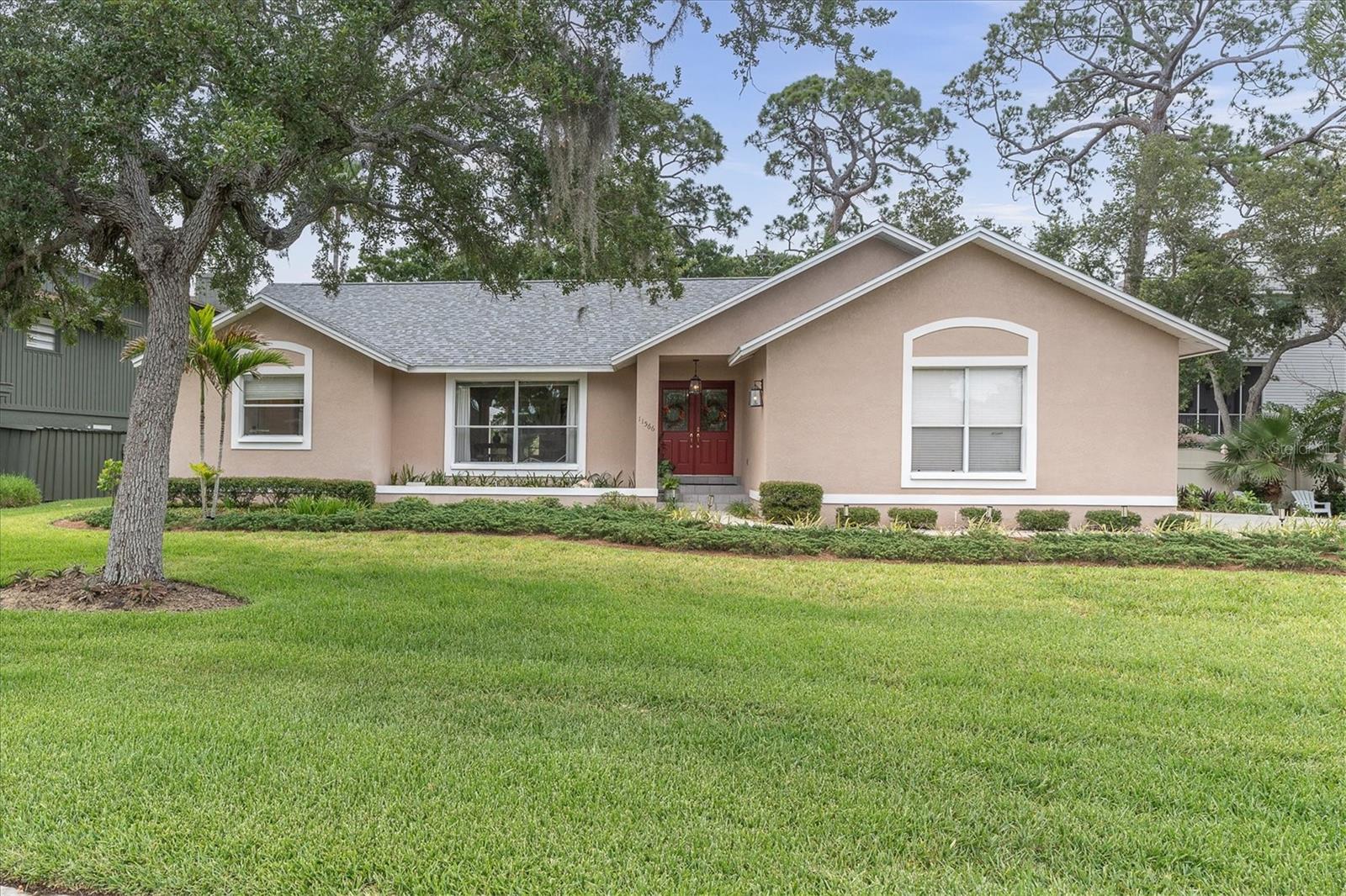 Fantastic opportunity that can be yours! Meticulously maintained 3-bedroom 2- bath, 2-Car garage 1989-constructed BLOCK home (1,857 htd. sqft) on nearly 1/3rd of an acre in vibrant “Oakhurst Shores” checks all the boxes! From the moment you arrive, you'll appreciate the well-manicured landscaped yard with long driveway on the side. Despite located in a dedicated flood zone, this beauty is built up to one-level living areas that were spared from Hurricane Helene's 2024 flooding ($3,300 flood premium). Step through the inviting red-painted double door into a welcoming flexible space that combines comfort with functionality, bathed in an abundance of natural light. A remodeled light wood-cabinet kitchen boasts Granite counters, a long breakfast bar & Whirlpool appliances. The lady of the house will appreciate the spacious INSIDE LAUNDRY ROOM with ample storage, “Whirlpool” & “Kenmore” washer/ dryer & access to the over-sized double garage to the side of home. Other features include: A/C in 2016, water heater in 2018, new shingle roof in 2025 with gutters, SPLIT BEDROOM floor plan, new carpets in all bedrooms and formal living areas, built-in book cases, canned lighting, ceiling fans, large panoramic window and several French doors overlooking a soothing tropical backyard oasis with Coconut palm, Sugar apple, Staghorn ferns and other succulent plants. Large master bedroom with ensuite bath (shower) and walk-in closet, ceiling fans, Quartz counter tops. A spacious covered lanai with back yard Gazebo invite for large gatherings and barbecues. There is plenty of room for a large swimming pool and the private backyard with Florida-friendly landscape will occupy the horticulture enthusiast & passionate plant lover. Surrounded by lovely well-kept homes and set in charming waterfront neighborhood known for its community feel, you're minutes from world-famous Gulf beaches, John's Pass, top-rated schools, Bay Pines Veteran's facility, Bay Pines Marina, a variety of dining, shopping & entertainment. Convenient access to Pinellas Trail, St. Pete College, local parks, Walmart, Slyce Waterfront Bar & Pizza Restaurant, Publix, library & post office (walking distance – Madeira Beach!), Texas Roadhouse, KOA campground, Starbucks, public boat ramps and both Tyrone & Seminole City Malls add to the appeal. ONE OWNER HOME!! Deed-restricted yet NO restrictions for renting (unincorporated Pinellas County). Hurry - schedule a showing today and explore all these possibilities!