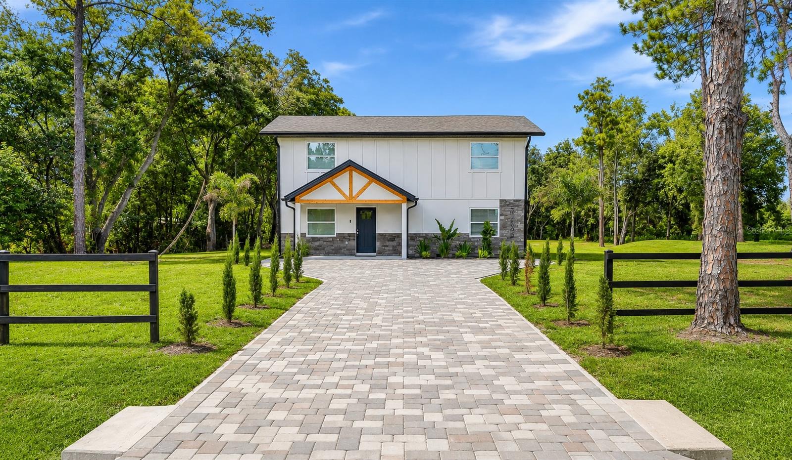 Essentially Rebuilt from the Ground Up on 1.03 Acres! This beautifully reimagined 4-bedroom, 2.5-bath home offers the perfect blend of modern construction, energy efficiency, and country-style living in the heart of Wesley Chapel. Nearly every major component of the home has been replaced, including a new roof, HVAC system, electrical, plumbing, septic system, well, spray foam insulation, impact-rated HVHZ windows and doors, flooring, kitchen, bathrooms, and finishes throughout.

Designed with today’s lifestyle in mind, the spacious floor plan features bright open living areas, a stunning kitchen, modern bathrooms, and quality craftsmanship throughout. The HVHZ-rated hurricane-impact windows and doors provide superior storm protection, energy efficiency, and peace of mind, while the spray foam insulation helps maintain year-round comfort and lower utility costs.

Situated on a private 1.03-acre lot, there’s plenty of room for a pool, workshop, RV or boat storage, outdoor entertaining, or future expansion. Enjoy the freedom and privacy of acreage living while remaining just minutes from shopping, dining, top-rated schools, and major highways.

A rare opportunity to own a virtually new home on over an acre with modern systems, premium upgrades, and no HOA restrictions. Move-in ready and built for years of worry-free ownership.

Some listing photos have been virtually staged to illustrate the property’s potential. Furniture, decor, and other enhancements shown in staged images are computer-generated and may not represent the current condition of the home.