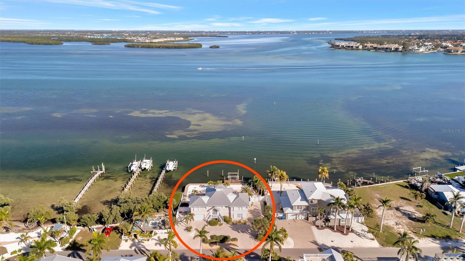 Rare opportunity to own a premier waterfront home offering unbeatable views of Sarasota Bay, boating access, and income potential. Situated on more than a quarter acre and just three blocks from the pristine Gulf beaches, this elevated, one-owner residence delivers the ultimate Florida lifestyle. From the moment you arrive, you’re greeted by sweeping, unobstructed bay views that set the tone for coastal luxury living. This 3-bedroom, 2-bath home features a highly sought-after split-bedroom floor plan, a spacious kitchen designed for entertaining, and space already in place for a future elevator. The expansive screened-in patio showcases breathtaking water views and seamlessly extends the living space outdoors. Step down to your private pool and spa overlooking the bay—an ideal setting for relaxing, hosting guests, and enjoying unforgettable sunsets as boats pass by. Calling all boaters! Enjoy the private dock and lift with direct access to Sarasota Bay and open water, perfect for cruising, fishing, or island hopping. Elevated construction provides peace of mind, while the two-car garage offers ample room for vehicles and water toys. A roof replaced in 2017 adds confidence and long-term value. Zoned for short-term rentals, this property stands out as a strong investment opportunity, luxury vacation home, or full-time waterfront residence. Homes with this combination of panoramic bay views, private boating access, generous lot size, rental flexibility, and walkable beach proximity are truly rare—don’t miss the chance to own your own piece of paradise.  Be sure to take a virtual tour through our Matterport platform.