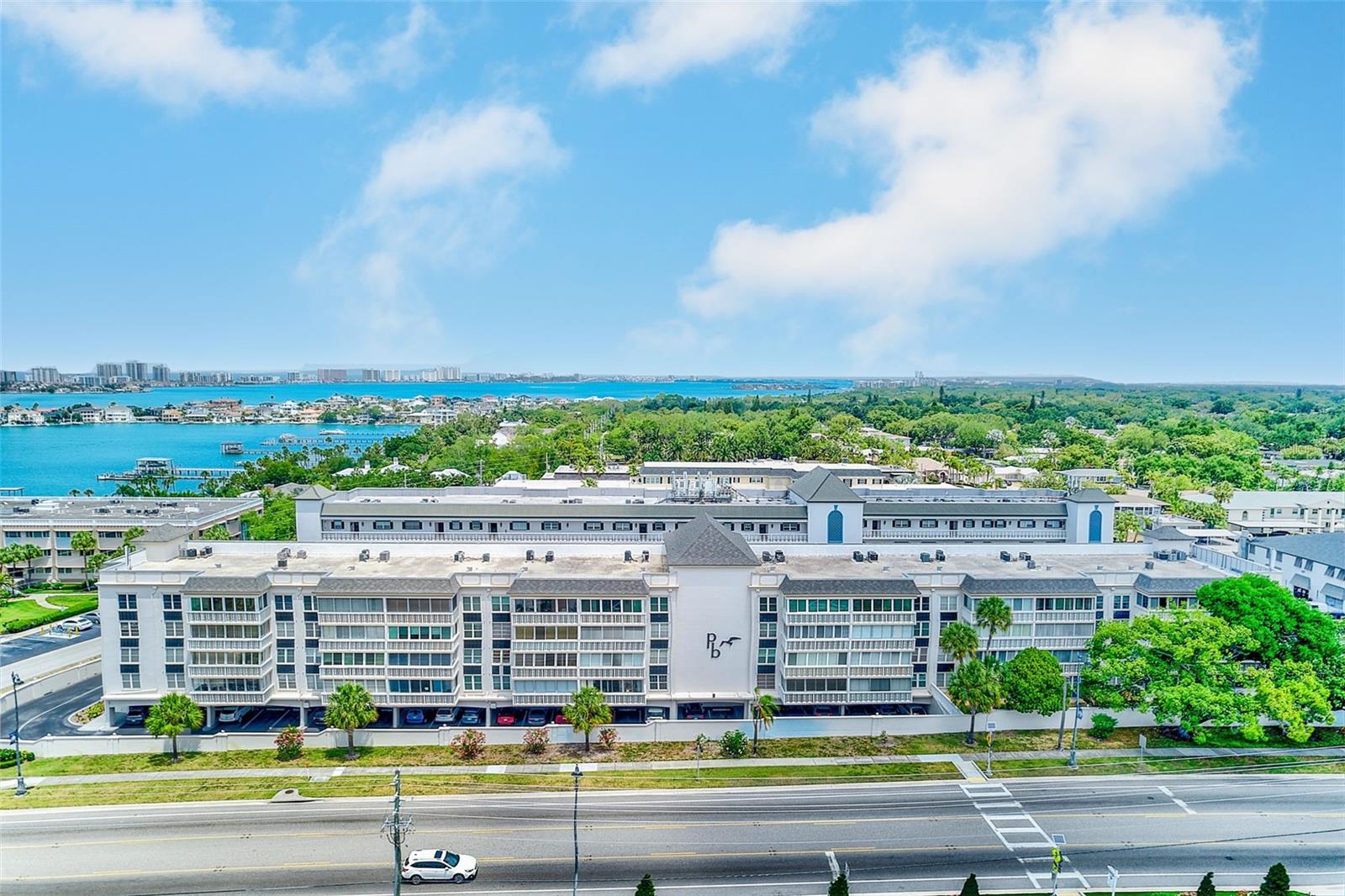 Welcome to your opportunity to live next to the Intracoastal Waterway in the highly sought-after Port Belleair community. This rare top-floor 55+ condominium offers an exceptional Florida lifestyle with 3 bedrooms, 3 bathrooms, and 1,980 square feet of living space. The residence includes two assigned covered parking spaces, a private storage unit, and the convenience of maintenance-free living in a bright corner penthouse-level unit. Recent updates include two new complete AC units, updated interior paint, and a remodeled guest bedroom. Designed for both comfortable everyday living and effortless entertaining, the home features a spacious open layout filled with abundant natural light. Upon entering, you are welcomed into an expansive living and dining area with an open, airy feel. The living space extends into a stunning 40x7 Florida room with operable windows, creating the perfect setting to relax, work from home, or enjoy beautiful sunsets and refreshing coastal breezes year-round. The oversized bedrooms each feature walk-in closets and en-suite bathrooms, offering privacy and comfort for both residents and guests. The spacious primary suite also includes a personal wet bar with a refrigerator, creating a private retreat within the home. From the unit, enjoy beautiful views of the Belleair Bridge and the surrounding area. Enjoy added peace of mind with no flood insurance required, completed milestone inspections, and fully funded community reserves. Ideally situated near shopping, restaurants, banking, and everyday conveniences, this home is also just moments from the Belleair Causeway and the Intracoastal Waterway. You will be close to parks, scenic walking paths, and only 2 miles from the dining and laid-back coastal charm of Indian Rocks Beach, as well as just 4 miles from Clearwater Beach. Don’t miss this exceptional opportunity to enjoy the Florida lifestyle in one of the area’s most desirable waterfront communities. Schedule your private showing today!