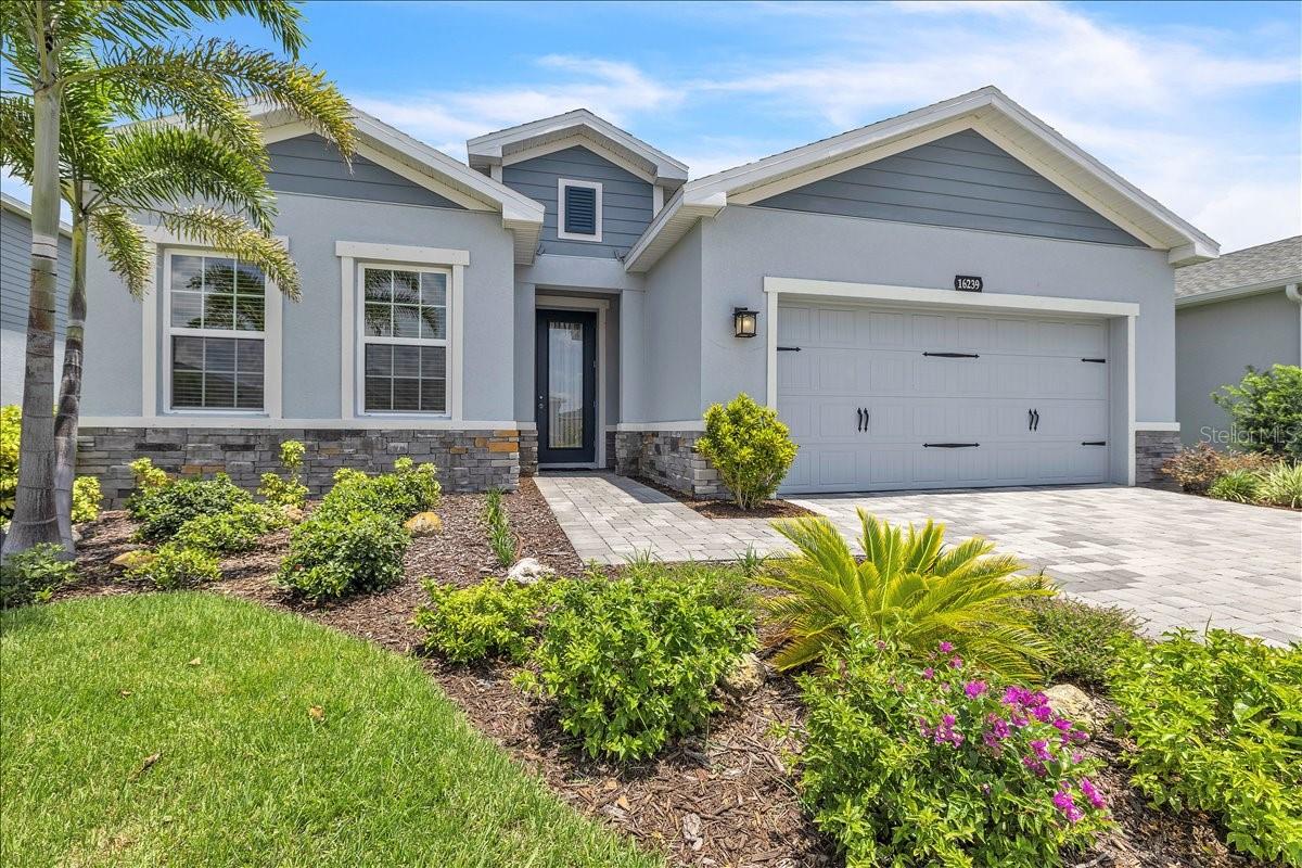 Nestled within The Palms at West Port, this beautifully maintained 3-bedroom, 2-bath home with a den/office offers 1,823 square feet of living space, thoughtfully blending modern comfort with scenic surroundings. From the moment you arrive, the home’s curb appeal stands out with its clean coastal design, soft gray tones, stone accents, and crisp white trim. A paver driveway leads to the spacious two-car garage, while the covered entry and sleek glass front door create a warm and welcoming first impression. Lush landscaping and tropical palms further enhance the home’s polished, move-in ready appeal. Inside, the open-concept layout creates a seamless flow ideal for both everyday living and entertaining. The light-filled great room features wide-plank flooring, neutral finishes, and recessed lighting, creating a bright and inviting atmosphere. A built-in fireplace feature wall serves as a stylish focal point, perfect for relaxing or gathering with guests.
The kitchen is equally impressive, offering shaker-style cabinetry with upper crown molding, quartz countertops, stainless steel appliances, and a center island with seating. A designer tile backsplash adds texture and visual interest, while the walk-in pantry closet provides ample storage. Adjacent to the kitchen, the dining area is filled with natural light and features sliding glass doors leading to the screened-in lanai, creating a seamless indoor-outdoor connection ideal for enjoying Florida’s year-round lifestyle. The split-bedroom floor plan ensures privacy, beginning with a spacious primary suite featuring a generous walk-in closet and plush carpeting underfoot—also continued throughout the guest bedrooms. The primary bath offers a luxurious retreat, complete with a large walk-in tiled shower with glass enclosure, built-in bench seating, and a transom window that brings in natural light. Dual vanities with ample cabinet storage provide plenty of space for daily routines, while modern finishes and a neutral color palette create a bright, spa-like atmosphere. A private water closet adds an extra level of comfort and privacy. Two well-appointed guest bedrooms offer built-in closets and share a full bath. The versatile bonus room, presently used as a secondary living space, can be adapted to suit your needs—whether as a home office, media room, fitness space, or guest retreat.  Step outside to unwind and enjoy the peaceful backyard setting—perfect for morning coffee, evening relaxation, or entertaining.  Offering a compelling alternative to new construction, this residence combines a newer build with upgrades already completed, immediate availability, and competitive pricing within the desirable West Port community. Residents enjoy close proximity to Centennial Park, featuring a community pool, sand volleyball courts, sports fields, playgrounds, and scenic walking trails. Baseball fans will appreciate being just minutes from the Tampa Bay Rays Spring Training facility. Conveniently located between Tamiami Trail and SR-776, you’ll have easy access to shopping, dining, healthcare, and everything Southwest Florida has to offer. Experience the perfect blend of comfort, convenience, and value in one of Port Charlotte’s fastest-growing communities.
**PLEASE ENJOY THE 3D INTERACTIVE VIRTUAL TOUR ASSOCIATED WITH THIS LISTING**