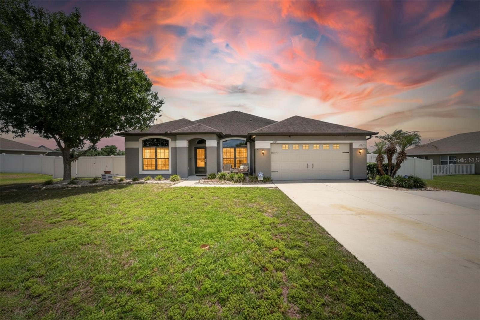 Bright, updated 3-bed, 2-bath home with 2,100 sq ft and a 2-car garage on a large, private lot—move-in ready!

Step inside to soaring ceilings, architectural details, and a smart, open floorplan that’s perfect for everyday living and entertaining. The kitchen and living areas flow to a covered lanai and additional patio—ideal for morning coffee or weekend BBQs. Enjoy low-maintenance ceramic tile throughout the main spaces with cozy carpet in the bedrooms. Primary suite offers comfort and privacy. Mature landscaping and vinyl fencing create a serene, tucked-away feel. Extras include plentiful ceiling fans, great natural light, and a well-cared-for, updated interior. Peaceful setting with considerate neighbors.