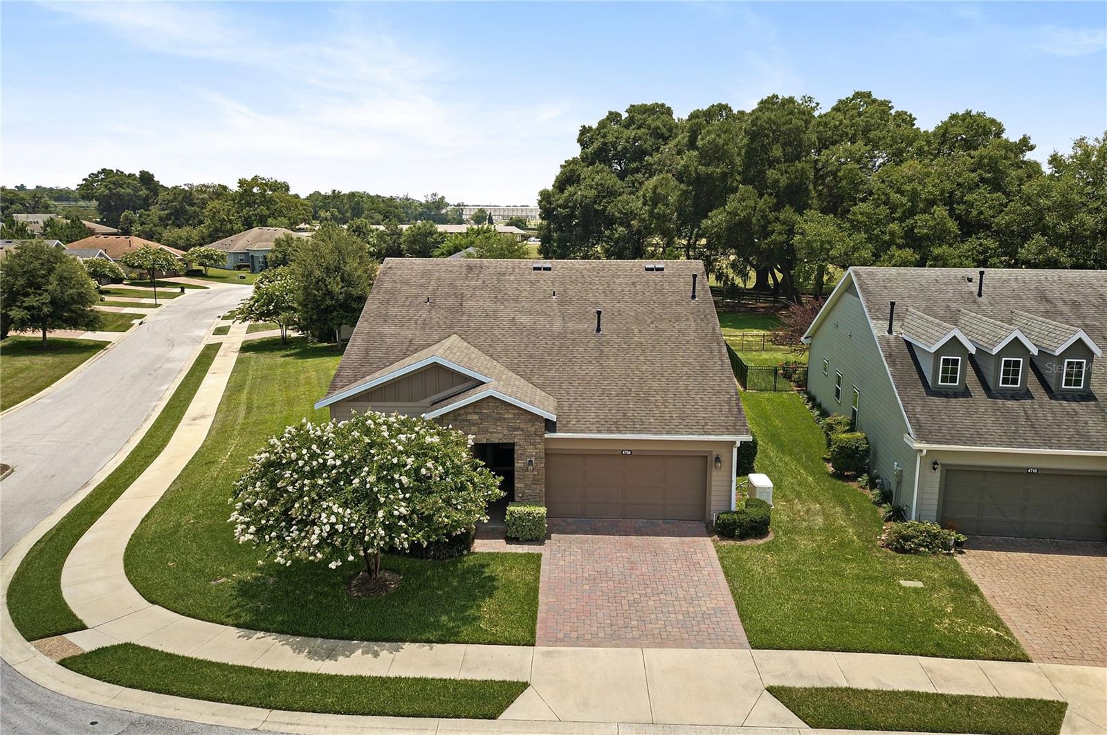 Located in the heart of horse country, just a short drive to WEC, HITS, FAST, and more - this Cannes model built by Shea is ready for new owners! Resting on an oversized corner lot backing up to a horse pasture, homes with this kind of view are few and far between. Through the glass front door, you are greeted with upgraded and beautifully designed tile flooring with accent designs, and volume ceilings. To your left you'll find your guest bedroom, currently being used as an office, the possibilities are endless. With extra shelving in the closet, this makes the perfect office, hobby space, or guest room! The front facing windows allow for plenty of sunshine and the guest bathroom is located just outside this room - and is complete with a shower/tub combo and vanity. The den is open but separated - adding to the open concept living area. Some have used this room as a formal dining room while others have used it as a sitting room. Again, the possibilities are endless in this model! The living room flows nicely into your eat in kitchen, great for entertaining. Solid cabinets and tile backsplash beautifully accent your peninsula island and stone counters. Off of the kitchen is the smart space which houses your washer and dryer and has extra cabinets installed for storage. Back into the main living area, you'll find the enclosed and carpeted lanai, which is under air with heat and AC complete with thermal glass windows, and views of the pasture. The master bedroom is generous in size and has beautiful backyard views through large windows! The ensuite bath has a nicely tiled stand up shower and dual sinks in the vanity. The walk-in closet is large enough for all of your personals! This whole house has so many upgrades/features, including but not limited to, new garage door opening system with motion sensing led lighting, water softener system, GENERAC WHOLE HOUSE GENERATOR, window tinting in the lanai as well as south and west sides of the home, and more. There is a hot water booster for the kitchen and master bath which speeds up the delivery of the hot water, as well as the whole house and major appliance surge protection throughout the home. The security system will stay, with exterior cameras and ring doorbell! These owners pulled out all the stops and the upgrades are endless!  Ocala Preserve offers Walking Trails, Lakeside Veranda & Boardwalk, Resort Spa & Fitness Facility, Tennis, Pickleball, and Bocce Facilities, Clubs and Bar, Resort & Lap Pool, Restaurant, and so much more. Call today for your private tour!