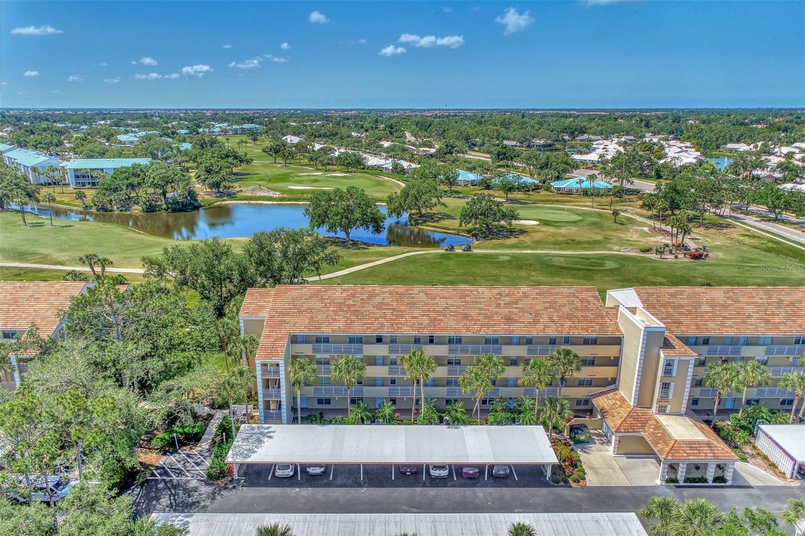 Appealing two bedroom, two bath, penthouse level condo, with golf course and water views, in the Eighth Fairway at Plantation Golf and Country Club. Your condo overlooks the eighth and ninth holes of the Bobcat Course. It features cathedral ceilings in your living room and dining room that make it more light, bright and open than it already is. There is a combination living room and dining room with sliders out the living room to your lanai and beautiful views. The kitchen has wood cabinets, breakfast bar and large closet pantry. The master bedroom has these beautiful views too and the master bath has two built-in closets and a laundry closet. The condo is being sold furnished. The AC system was replaced in 2016 and the water heater was replaced in 2017. The roof was replaced in 2020 for the building and the exterior was painted in 2020 as well. The community offers a heated pool and clubhouse and has an onsite maintenance person. Membership is optional to this outstanding 36 hole championship course. Come see this great buy today!