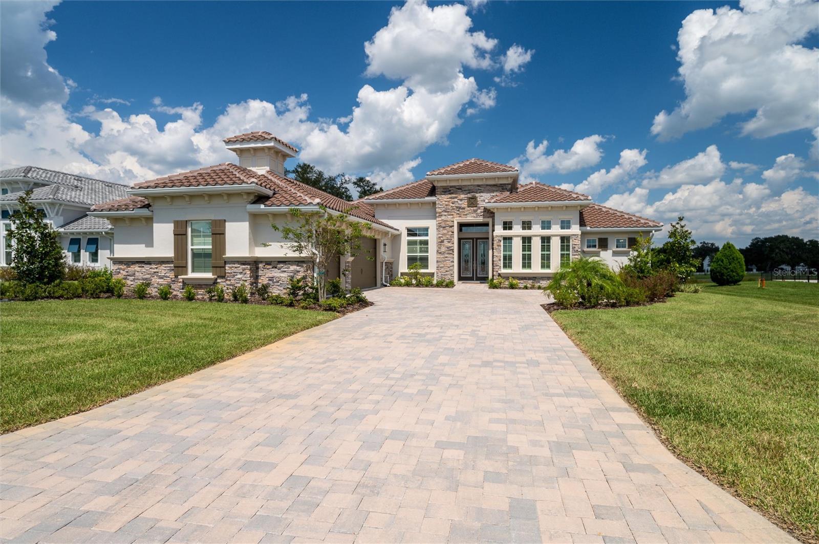 A rare find, 2 year old popular Egret model on over a ½ acre in the Bluffs. With both lake and golf course views, this is a must see. As you walk into the home, you are greeted by a large dining room on one side and a flex room on the other. The giant gathering room is the heart of this home and includes a stone fireplace, luxurious gourmet kitchen with nook and upgraded appliances. The master suite features plenty of privacy, large his and hers walk-in closets and a spacious bath with separate vanities. Two en suite guest bedrooms on the other side of the home allow enough space for everyone. A functional utility/laundry room leads to the 3-car garage. Membership to the Lake Jovita Club and Golf are available as an option.