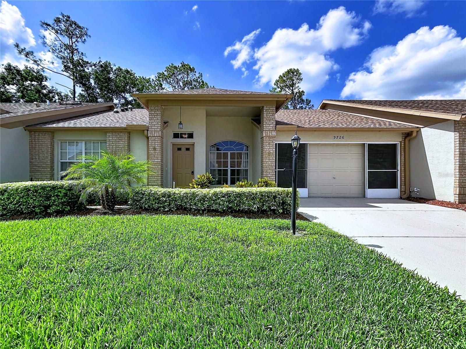 Welcome to this beautifully renovated 2-bedroom, 2-bath villa nestled in the highly desirable Timber Greens 55+ golf community. Perfectly positioned overlooking the 12th hole, this home offers breathtaking golf course views and the relaxed Florida lifestyle you've been dreaming of. Start your mornings with a cup of coffee on the enclosed porch or back lanai while taking in the peaceful, meticulously manicured fairways. Inside, you'll immediately appreciate the soaring ceilings, abundant natural light, and stunning views that create a bright, open, and inviting atmosphere. The fully remodeled kitchen is designed for both everyday living and entertaining, featuring custom cabinetry, quartz countertops, updated lighting, stainless steel appliances, and an open-concept layout that flows seamlessly into the living area.
The spacious primary suite serves as a private retreat with a large walk-in closet, an additional storage closet, and a beautifully updated en-suite bathroom complete with custom cabinetry, quartz countertops, a walk-in shower with new glass enclosure, updated mirrors, and modern lighting. A generously sized second bedroom provides the perfect space for guests or a home office, while the renovated guest bathroom showcases a new vanity, updated lighting, a new mirror, and a glass shower/bath enclosure. Beyond the home, Timber Greens offers an exceptional resort-style lifestyle with amenities designed to keep you active and connected. Residents enjoy a championship golf course, a beautiful clubhouse, an on-site restaurant, a resort-style swimming pool and spa, a well-equipped fitness center, card room, tennis courts, pickleball courts, and a full calendar of socializing and events. Whether you're spending the day on the course, enjoying lunch with friends at the 19th Hole Bar & Grill, or participating in one of the community's activities, there's always something to enjoy.
Conveniently located near shopping, dining, medical facilities, Gulf Coast beaches, and Starkey Park which offers over 8,000 acres of hiking, biking, and camping. This move-in-ready villa offers the perfect combination of peaceful golf course living and everyday convenience. Major updates provide added peace of mind, including a new roof (2026) and A/C (2024). Don't miss this rare opportunity to own a beautifully updated golf course villa in one of the area's most sought-after 55+ communities. Schedule your private showing today!