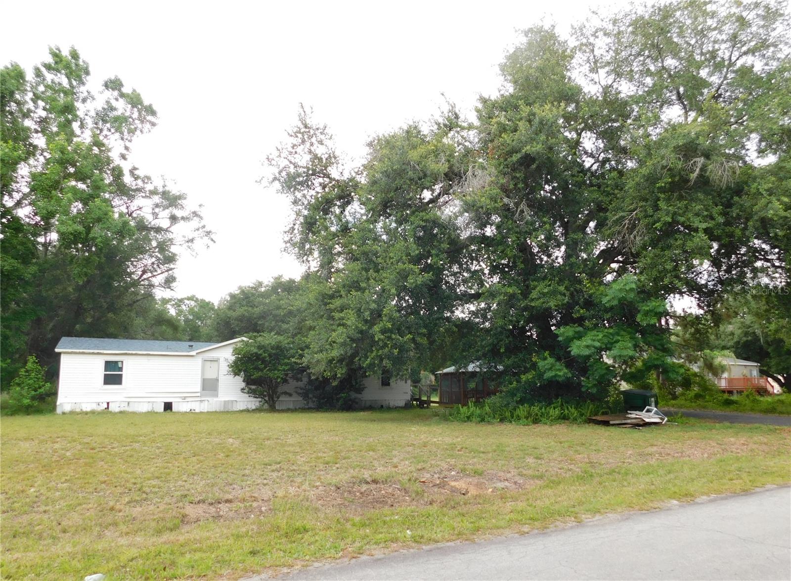 Escape the HOA’s and CDD’s!  Nestled on over an acre in a peaceful Wesley Chapel neighborhood, this unique property offers endless potential for multigenerational living, rental income, or a private homestead retreat. the property features 2,835 square feet of living space with two homes one built in 1995 1,620 sq feet and one built in 2000 with 1215 sq feet. The most expensive repairs have been made.  Both homes got new roofs in 2021, New A/C units on both homes in 2019, the front home has newer windows 2021 & large door replaced.   The land has flexible-use opportunities. Zoned Agricultural, Homes are located in Flood Zone X other zones are front and back of property. 
Surrounded by mature trees and open space, the home provides a rare blend of privacy and rural charm while remaining conveniently close to shopping, dining, schools, and major roadways. The Agricultural Residential zoning allows for a spacious lifestyle with room for recreational vehicles, workshops, gardening, pets, livestock, or hobby farming. A lot of the neighbors have farm animals.  Zoning allows mobile home or single family homes. Only deed restriction known of is no more than 2 homes allowed per acre of land.
The property’s expansive grounds and low-density neighborhood create a serene setting ideal for those seeking country living with modern accessibility. Whether you envision updating the existing residence, creating an income-producing property, or enjoying the freedom of wide-open space, this Wesley Chapel gem presents a unique opportunity in one of Pasco County’s rapidly growing areas. You can walk to Wesley Chapel School Complex or the Wesley Chapel Community park on Boyette.  Close to Epperson Lagoon and easy access to I-75.
Main home features A wonderful 4 bedroom, 2 bath open layout, Fenced back yard, paved driveway, A beautiful gazebo that is in like new condition, And a 10X 12 Shed that is in new condition inside the fenced part of the yard. All Bedrooms are nice sized with walk in closets. 
2nd home has 3 bedrooms, 2 baths, All bedrooms have walk in closets, indoor utility room, Fireplace and large storage building. It is the home that needs more work. 

Taxes are higher on this property then neighboring homes due to PACE loans. 

The insides of the homes will need extensive remodeling for that reason we are looking for Cash offers only!! If you are super handy these may be the homes for you.  Schedule your private showing today before they are gone! Both homes have virtual walkthroughs attached in MLS