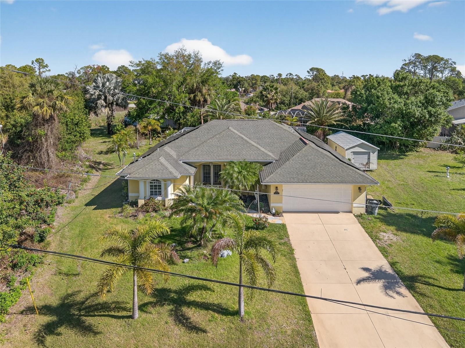 More than half an acre situated on two home sites (0.68 ACRES)! TONS OF POTENTIAL IN THIS 3 BEDROOM, 2 BATH, 2-CAR GARAGE POOL HOME TO MAKE IT YOUR OWN! Whole home solar system provides energy efficiency and monthly savings. French doors lead into an open floor plan with high ceilings, crown molding, plantation shutters, large slider to lanai, formal dining room, spacious kitchen with granite counters and overlooks family room. Primary suite features private bath with dual sinks, garden bath and walk-in shower. Split floor plan provides privacy for all with two nicely sized guest bedrooms and separate full bath plus there is a convenient inside laundry with extra storage. Outside entertaining area features covered lanai and heated screened pool overlooking expansive backyard with outdoor shed for more storage and plenty of room for furry friends to roam. Lush tropical landscaping surrounds the property giving it curb appeal. Newer a/c and hot water heater plus accordion shutters across lanai. Great location close to I-75 for commuting north or south, restaurants, shopping, schools, parks and a short drive to Venice beaches. Don’t miss this opportunity! Schedule your private showing today!
