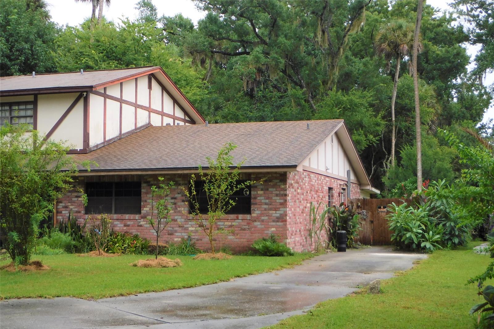 Investor Alert!! Also great starter home or for retirees. 1 story end unit of an attached 4-plex townhouse. No maintenance brick design over block construction. Spacious living room & dining area with a skylight and stylish tiled floor that looks like wood planks. Tile floors in kitchen, hallway, both full bathrooms & laundry closet.  Pull down stairs to attic storage area. Carpet in large master bedroom & guest bedroom. Sliders from living room out to a tiled enclosed porch with sliders to fenced back yard. Double wide driveway entrance with long single wide driveway for multi-car parking. Beautiful setting of mature trees. No HOA. Lovely Sugar Forest community convenient to parks, shopping, medical & professional office corridor and a short drive to bridge leading to the beach. ;Water: City