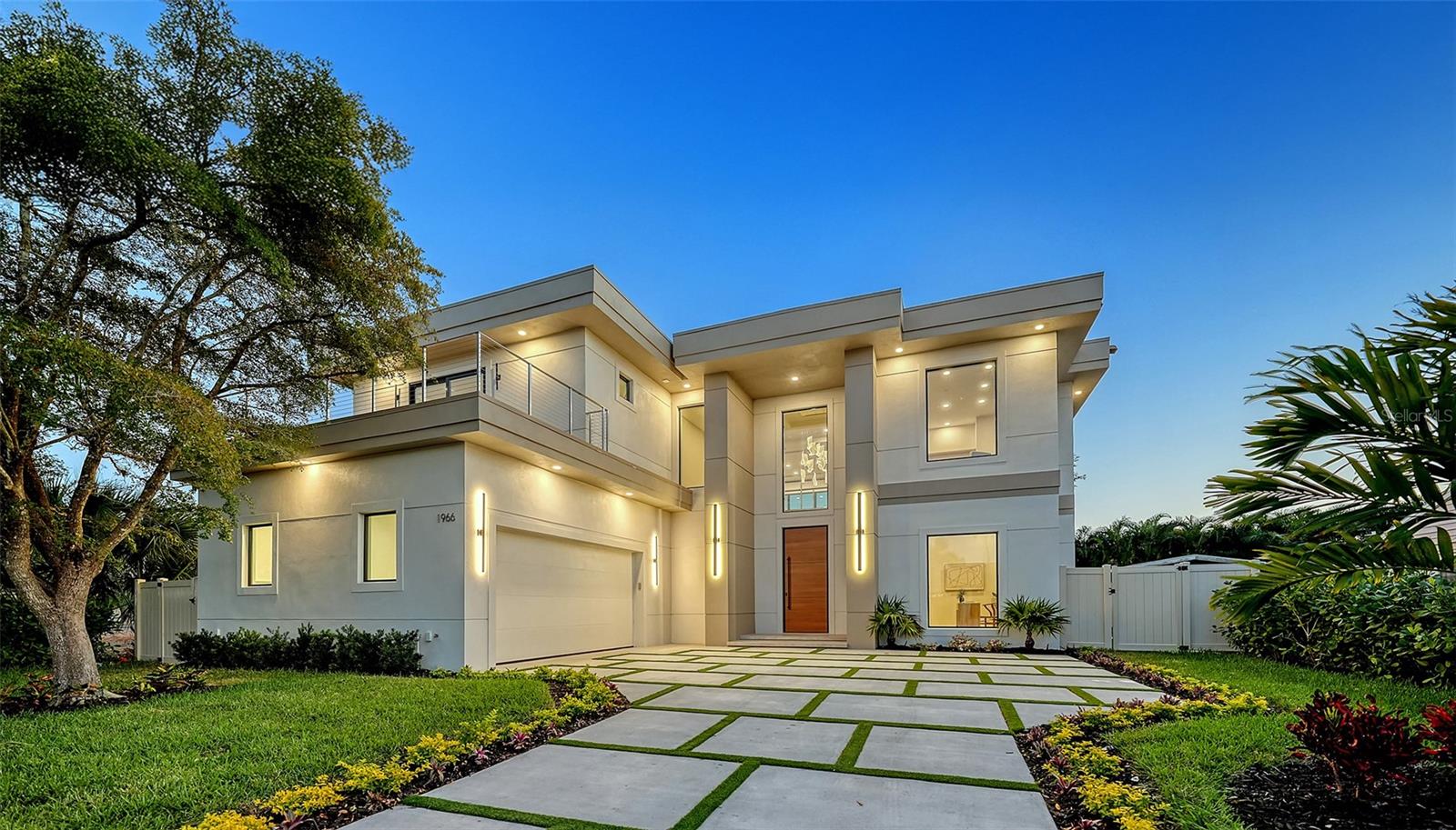Under contract-accepting backup offers. Set within the coveted West of the Trail enclave, this newly constructed estate is a striking statement of contemporary design and quality craftsmanship. Thoughtfully designed with clean architectural lines and seamless indoor-outdoor flow. Exceptional attention to detail throughout the residence with 4-bedrooms + office/den + bonus loft and 6-bathrooms. European engineered hardwood and porcelain tile flooring, 9-foot interior doors, recessed ceilings and lighting, and a Level 5 wall finish. PGT impact-resistant, Low-E windows and expansive sliding glass doors flood the interiors with natural light. The open-concept great room is a dramatic focal point, featuring a soaring double-height ceiling and a striking slatted wood accent wall. State-of-the-art kitchen with premium Thermador appliance package, custom Studio Luxe cabinetry by Miralis, quartz countertops, and a waterfall island with designer breakfast bar seating. Opening seamlessly to the dining area and covered lanai, creating an ideal setting for entertaining. Large walk-in pantry, dedicated laundry room with Electrolux washer and dryer, elevator-ready storage space, and private office ensure everyday convenience is met with elegance. The main-level primary suite serves as a private retreat, featuring a spa-inspired bathroom and professionally designed, boutique-style custom closet. The second level offers three en-suite bedrooms, each with beautifully finished bathrooms and walk-in closets. Bathrooms are appointed with quartz countertops, LED mirrors, frameless glass shower enclosures, designer tilework, multiple shower heads, built-in niches, and integrated bench seating. A spacious loft lounge includes a wet bar with beverage refrigerator. Two expansive balconies provide additional space for relaxation or entertaining. Enjoy serene moments by the heated saltwater pool and integrated spa, covered lanai with summer kitchen, including grill, sink and refrigerator, and a dedicated poolside half bath. The backyard is fully enclosed with a six-foot privacy fence and includes green space suitable for pets or gardening. The pool area is screen-enclosure ready for year-round enjoyment. Ideally located just minutes from downtown Sarasota, top-rated schools, dining, shopping, and cultural attractions, this exceptional residence offers a rare opportunity to enjoy sophisticated West of Trail living with uncompromising design integrity and quality. Offering a one-year full developer warranty.